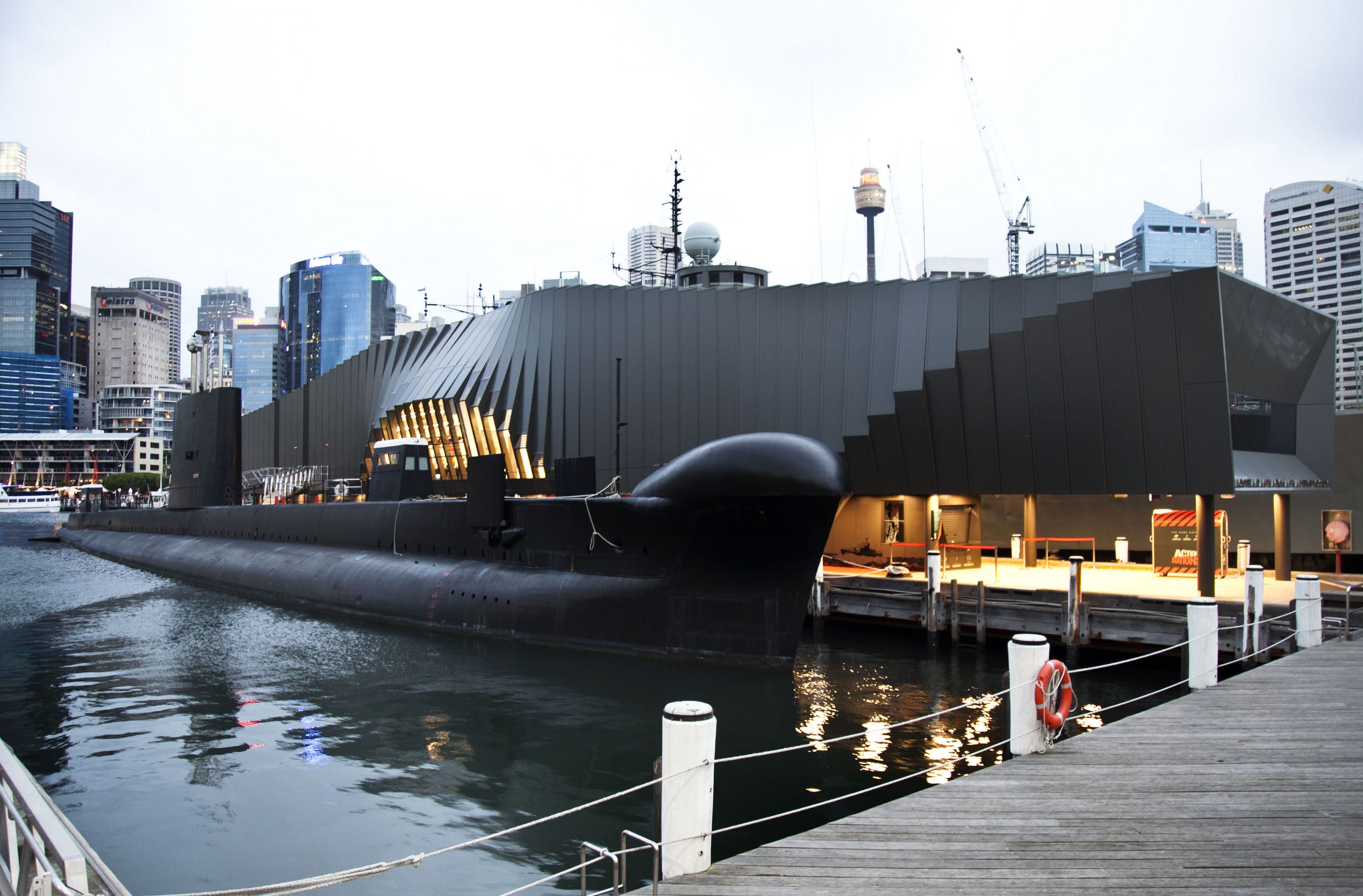 An exterior view of the Waterfront Pavilion building and the black submarine HMAS ONSLOW