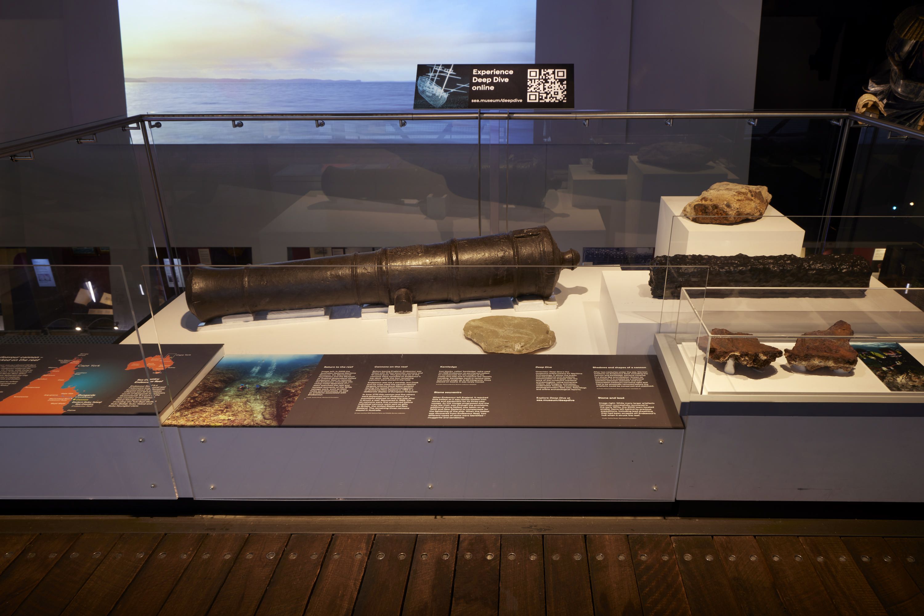 Photo of a museum display featuring a metal cannon 