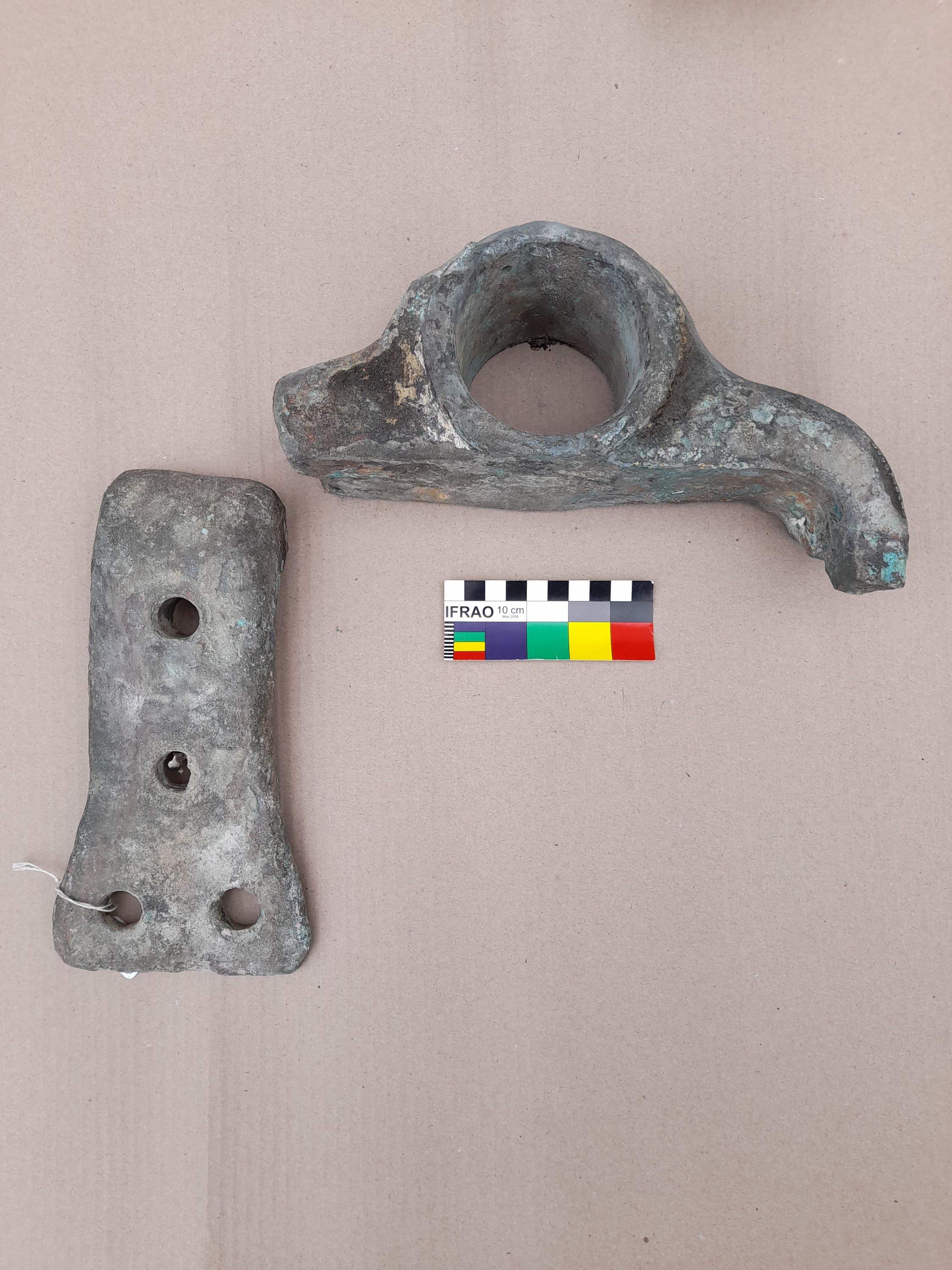 Photo of a metal object, broken into 2 pieces.