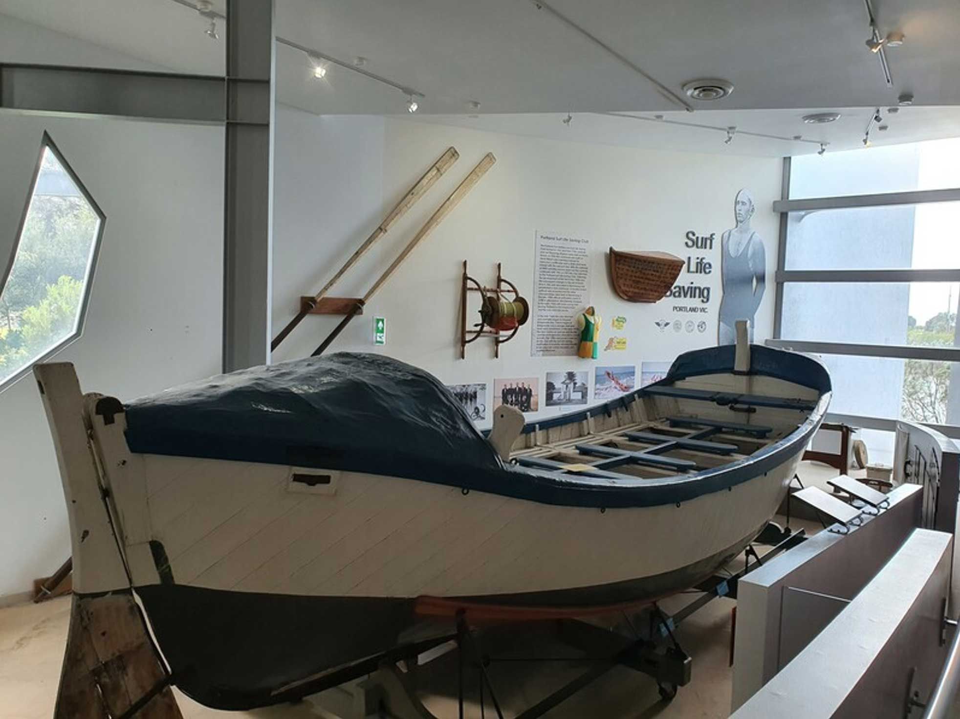 Photo of a museum exhibition space featuring a boat.