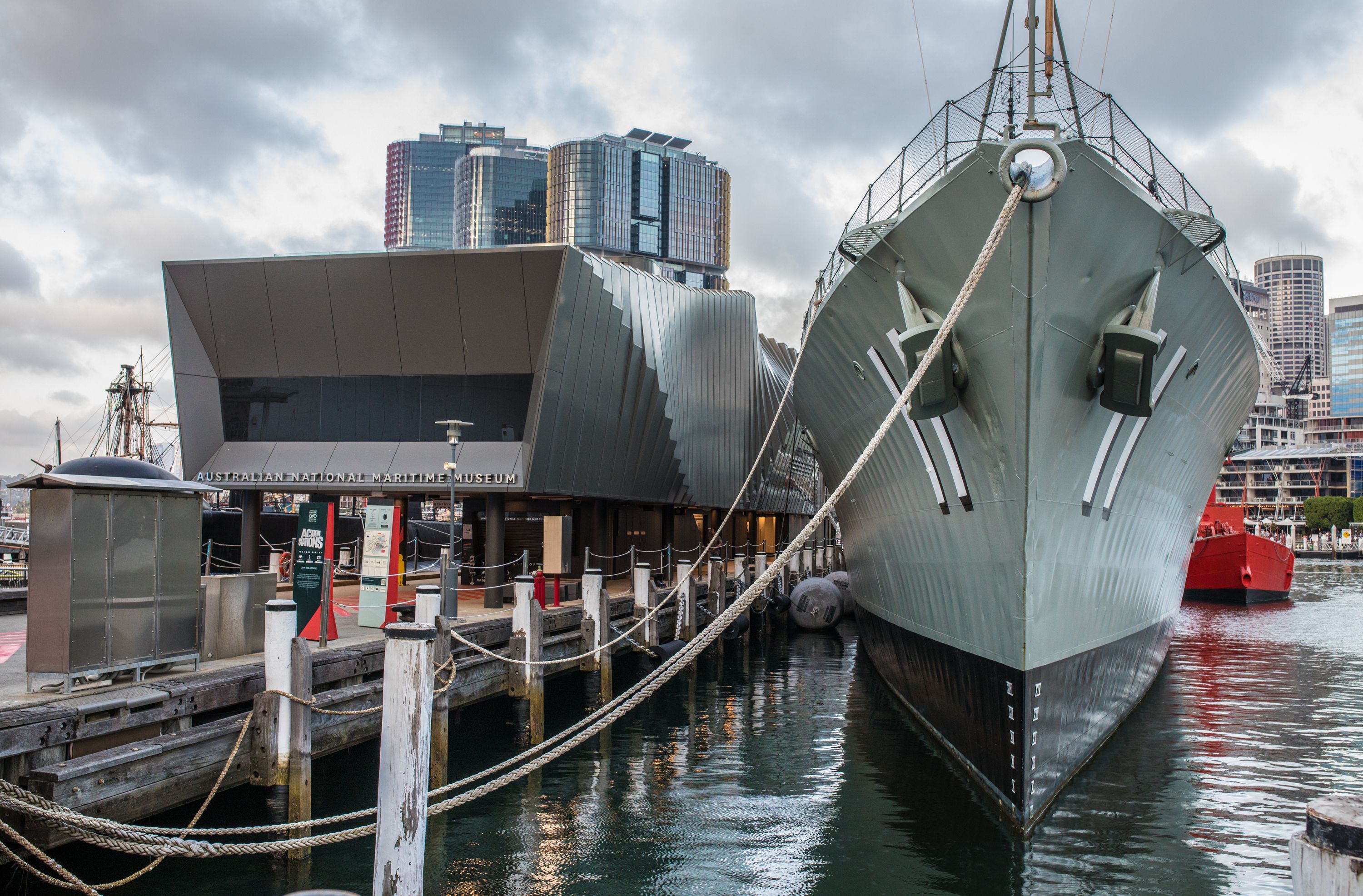 Photo showing a later afternoon view of the entrance to Action Stations - Waterfront Pavilion with the destroyer HMAS VAMPIRE at berth on the right.
