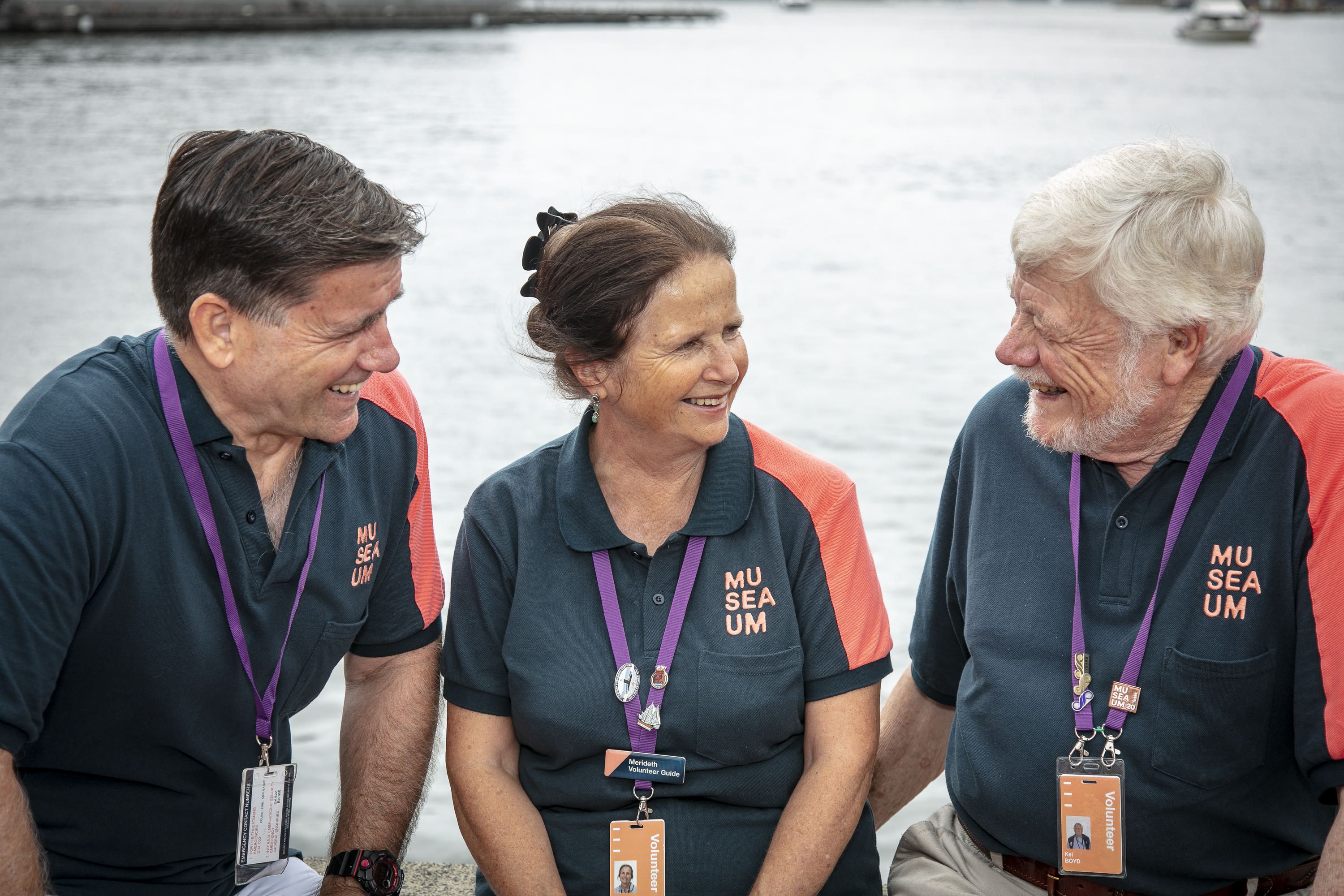 3 Volunteers, 2 men and a woman in Museum uniforms