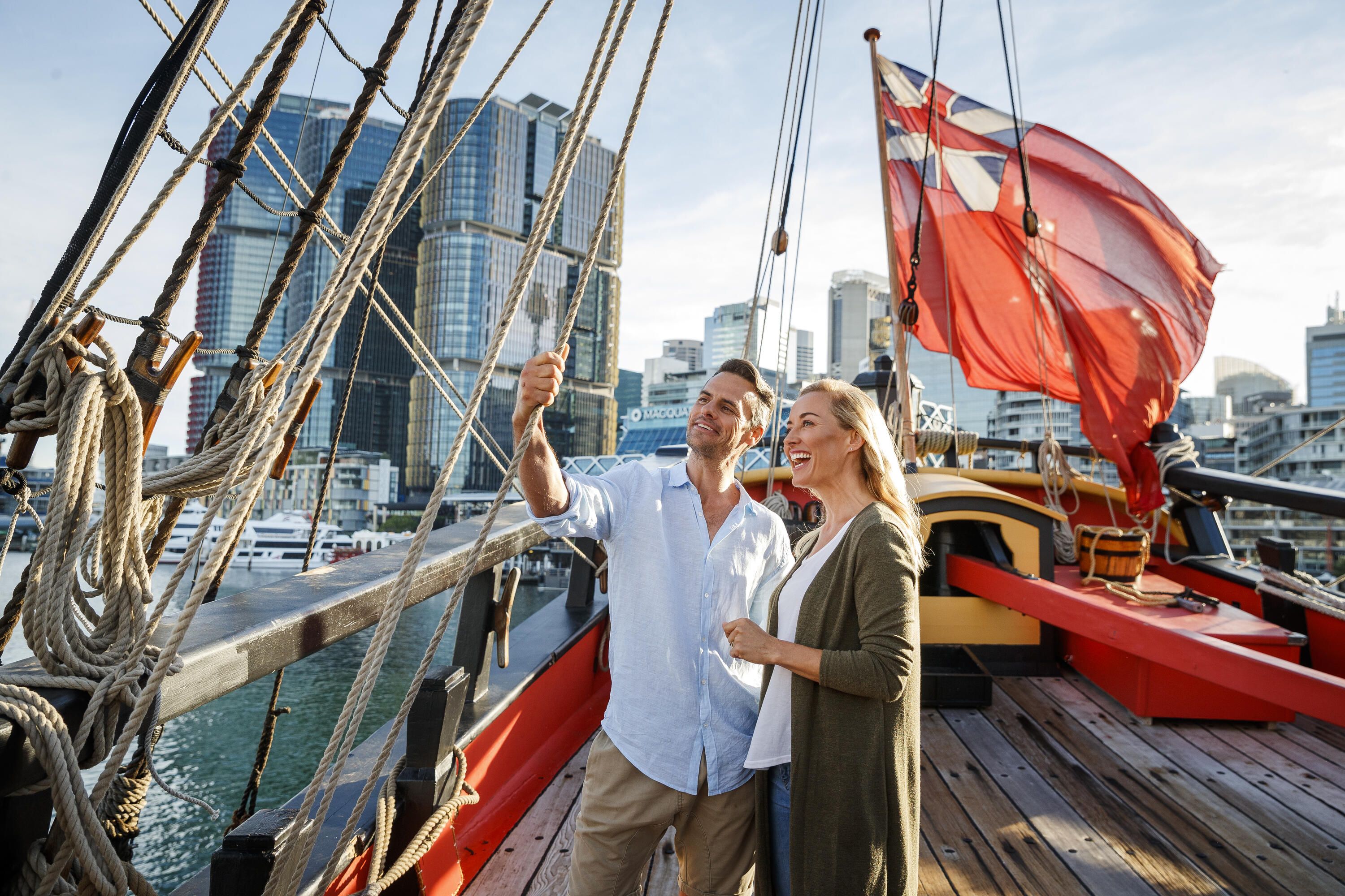 Photo of a couple standing on the upper deck of a tall ship.