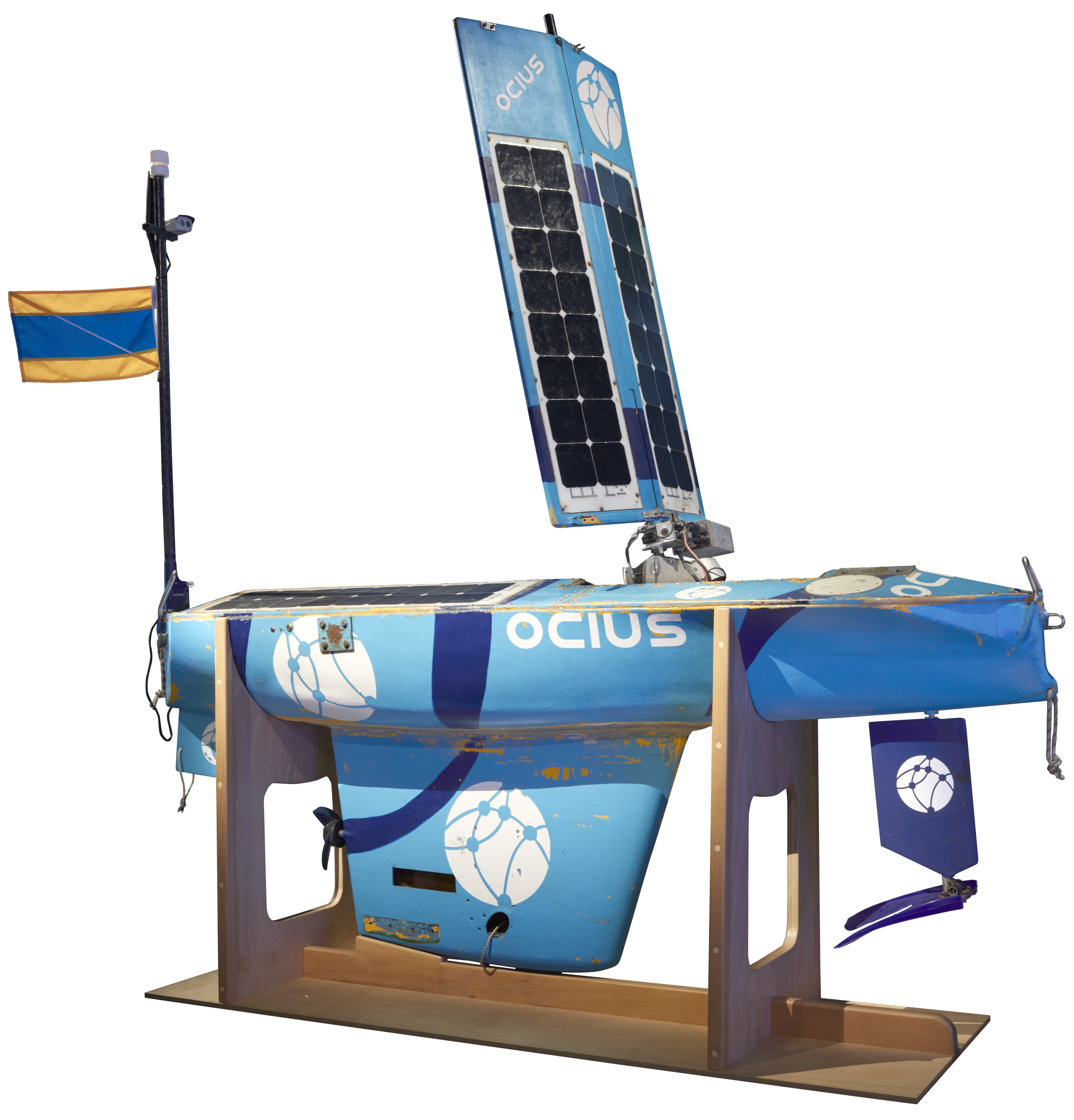 Blue Nemo unmanned surface vessel (USV) scale test propulsion model. It looks like a boat, but with a large square sail that has solar panels on it.