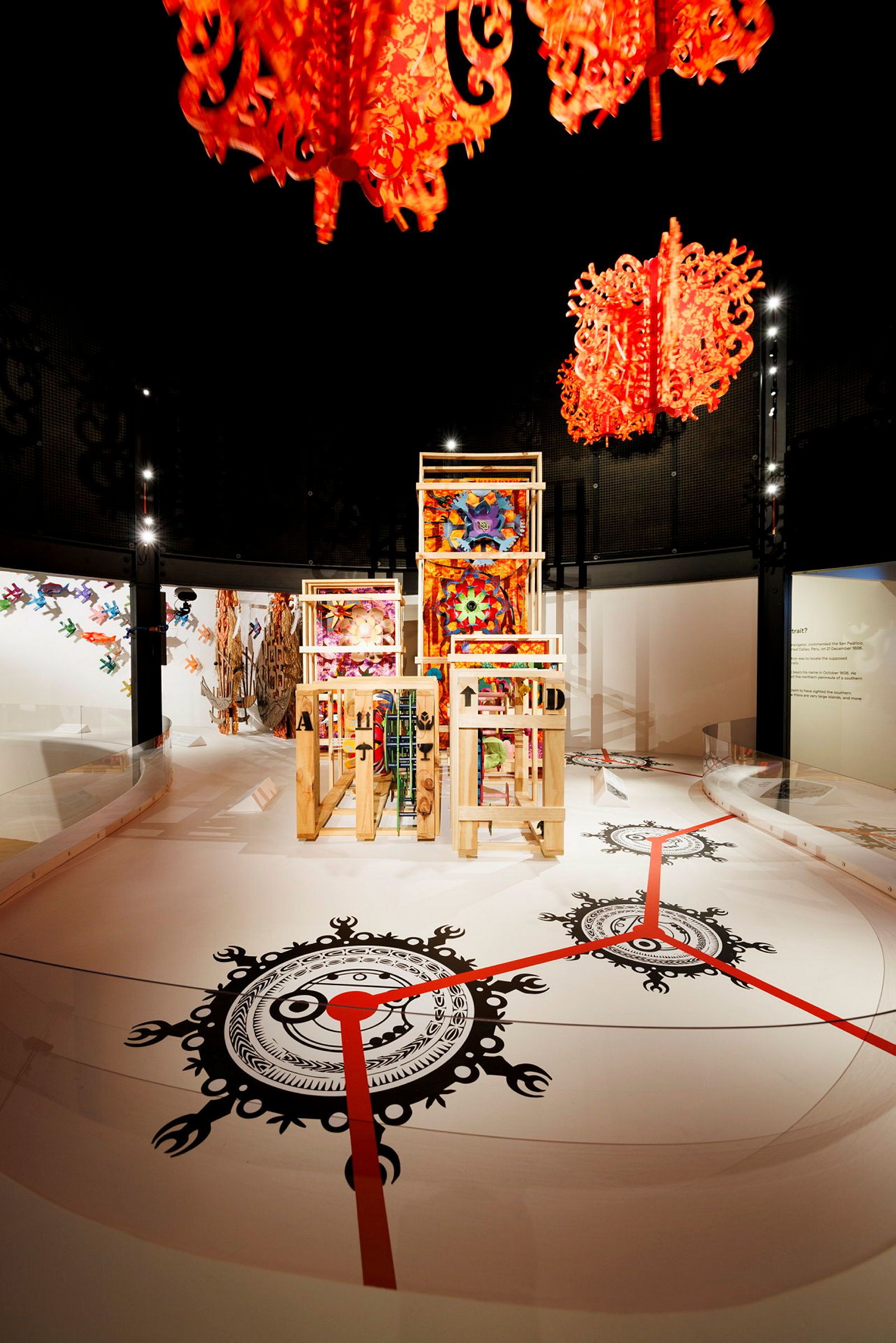 Photo of a museum exhibition space with colourful, patterned sculptures. 