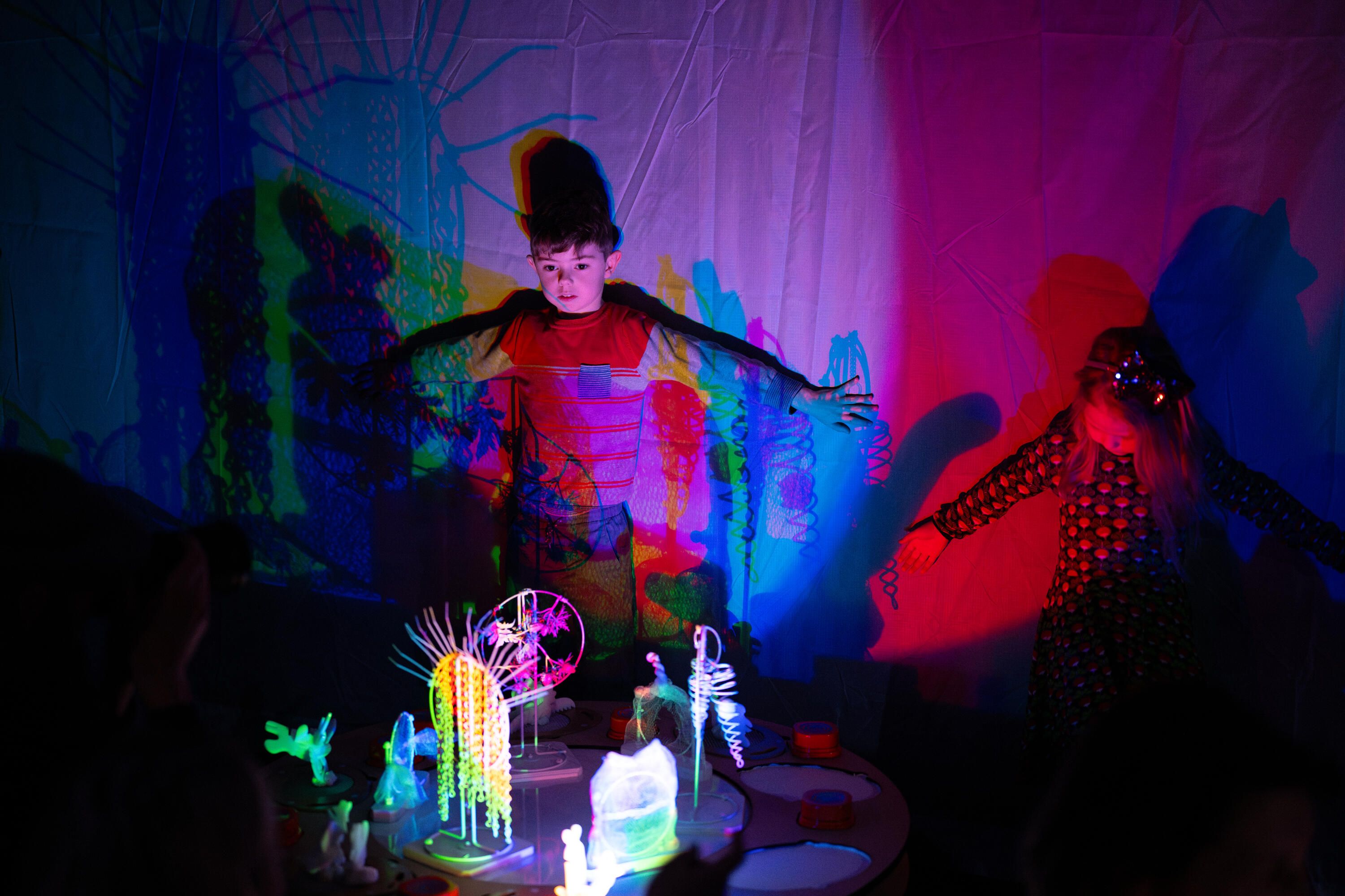 Children with coloured lights and props