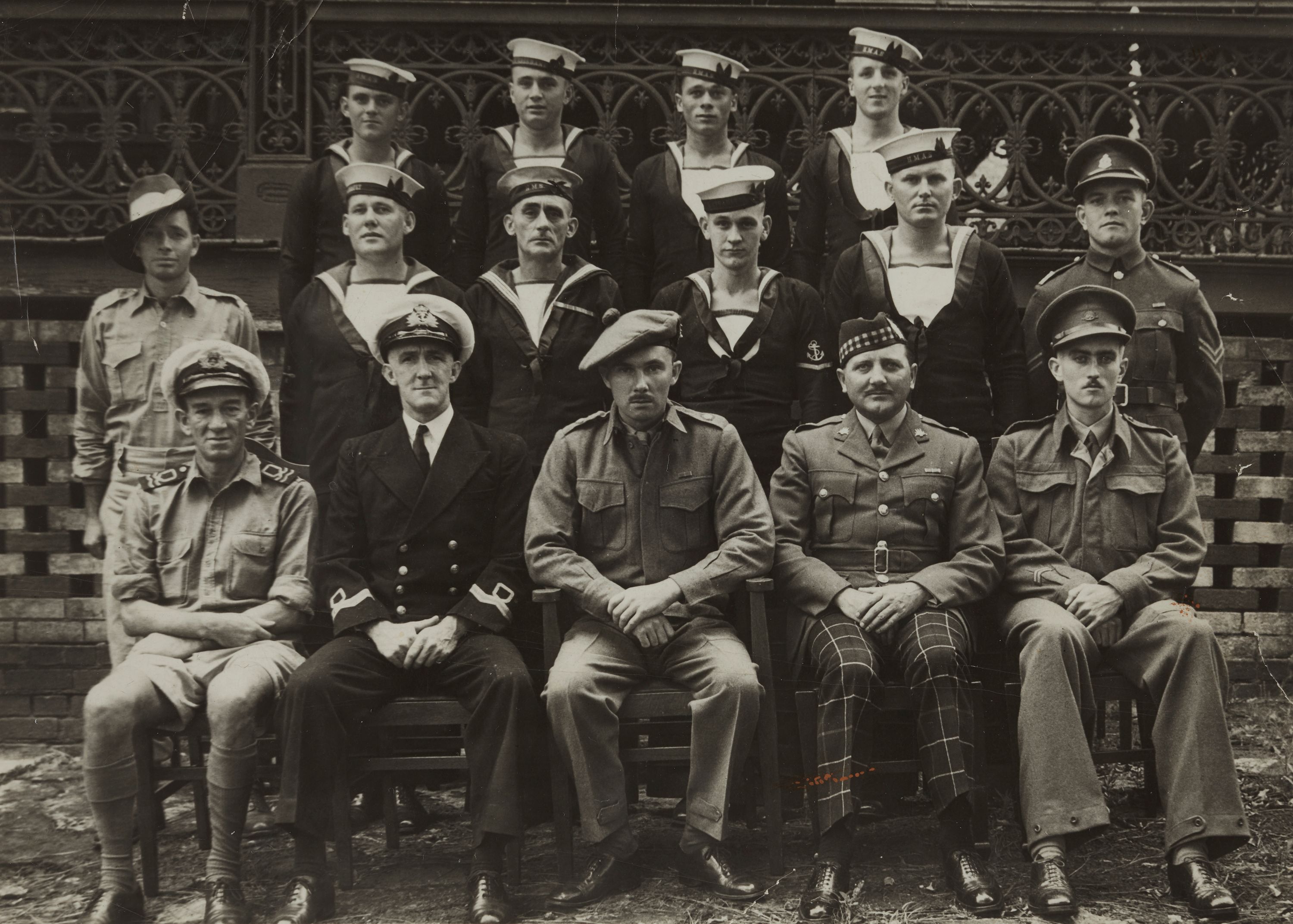 Black and white photograph showing a group of men in several different mititary uniforms.  The front row of 5 men are sitting, and there are 2 rows of men (6 and 4) standing behind. 