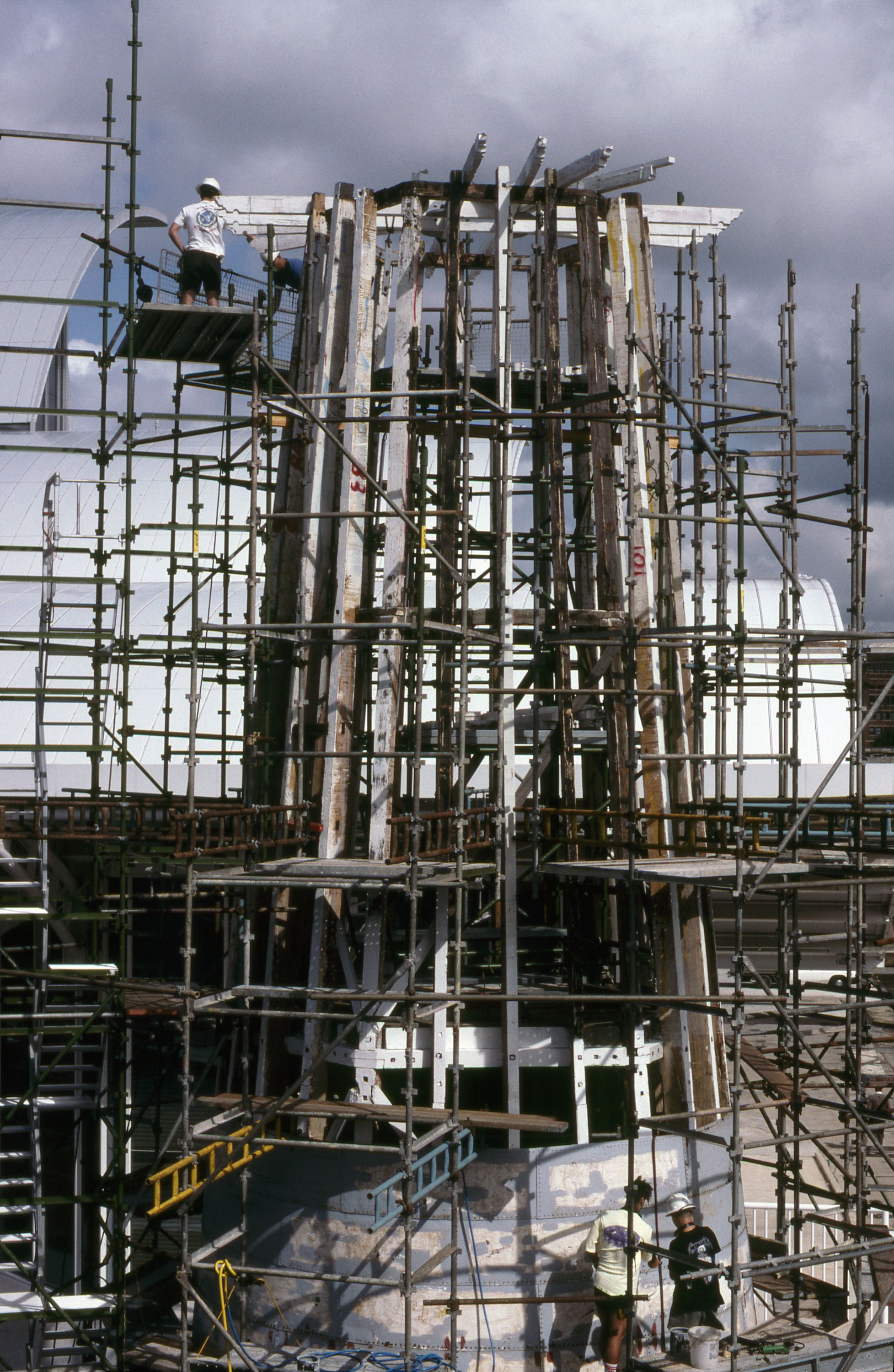 Photograph of an elevated view of the lighthouse covered in scaffolding.