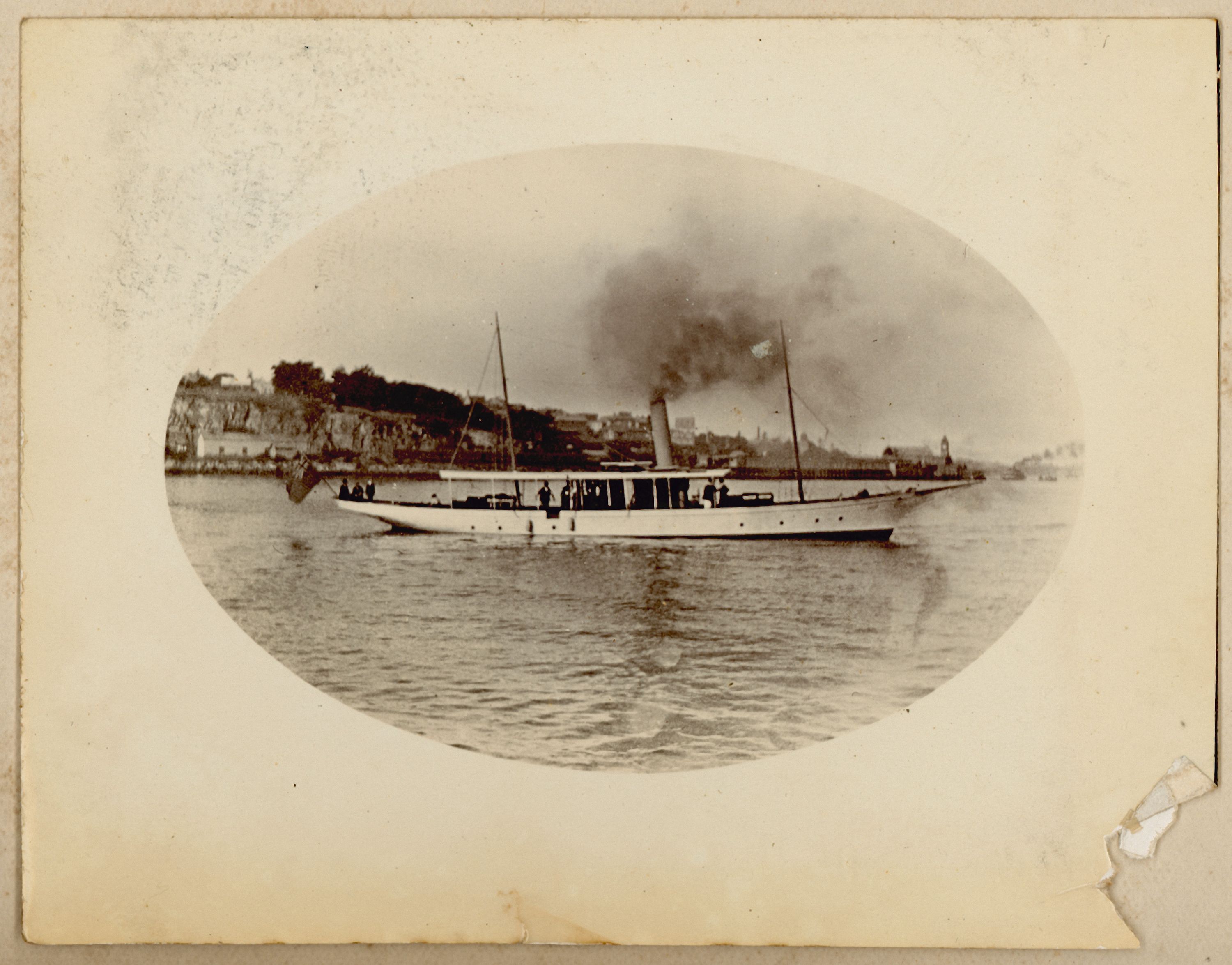 Black and White photo of long elegant steam ship Ena, paper yellowed with age.