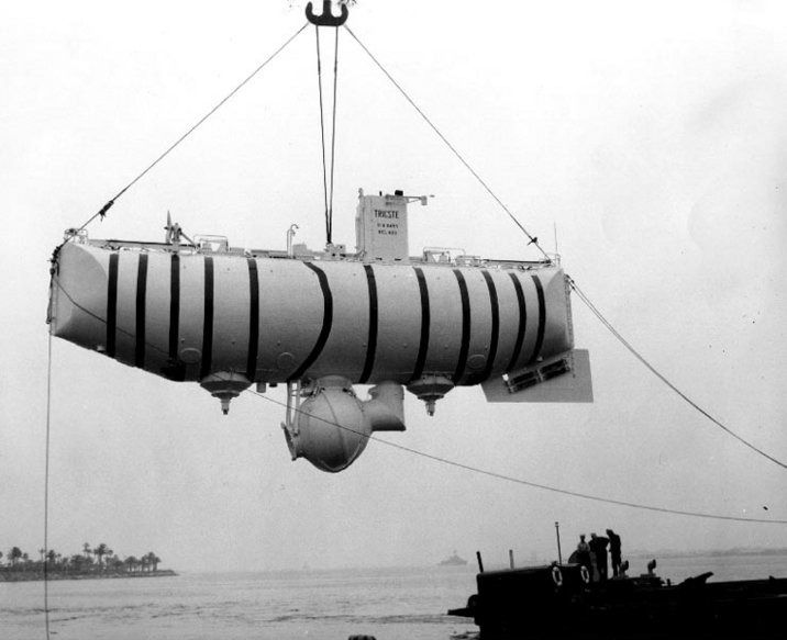 Black and white photo of a submersible being lifted by a crane.