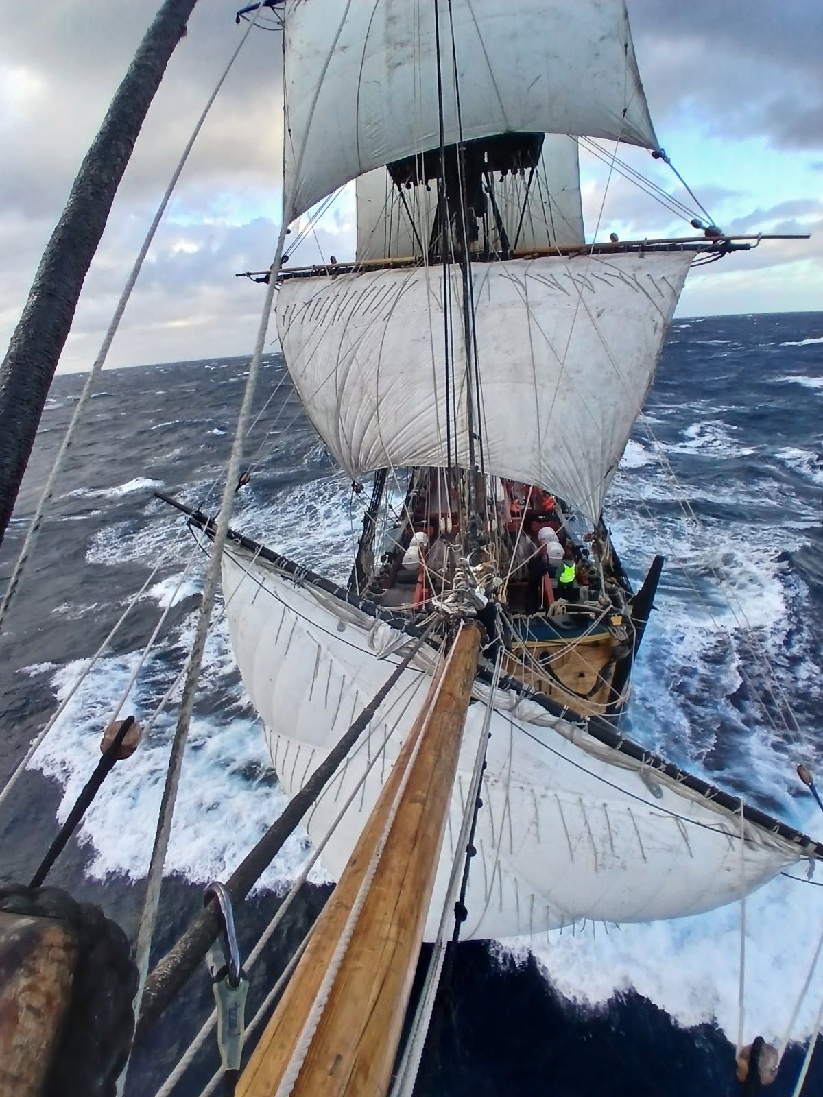 Photo taken of tall ship endeavour, from the front looking back at the sails full of wind. 