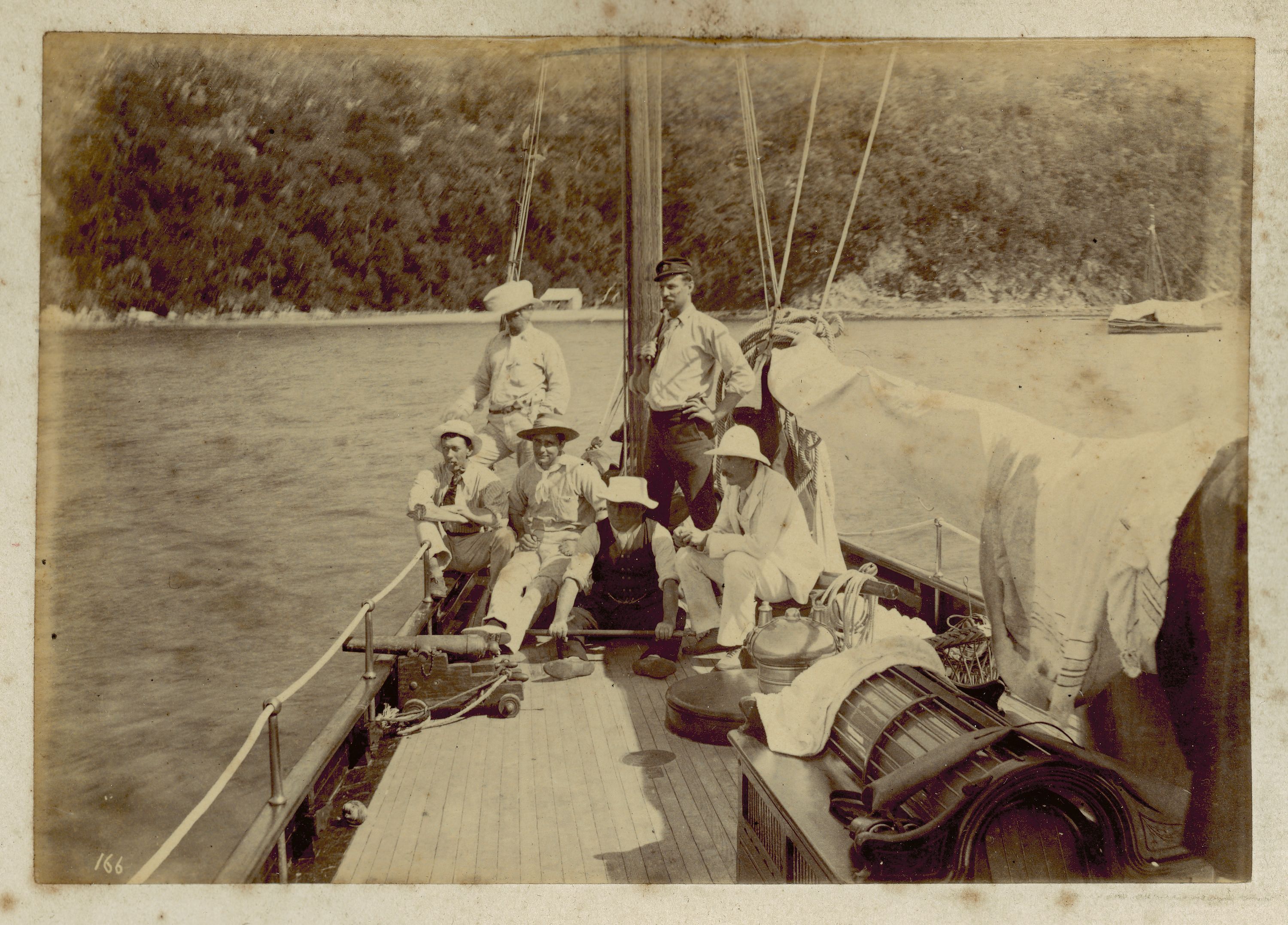 black and white photographic print showing a group of people on a boat 