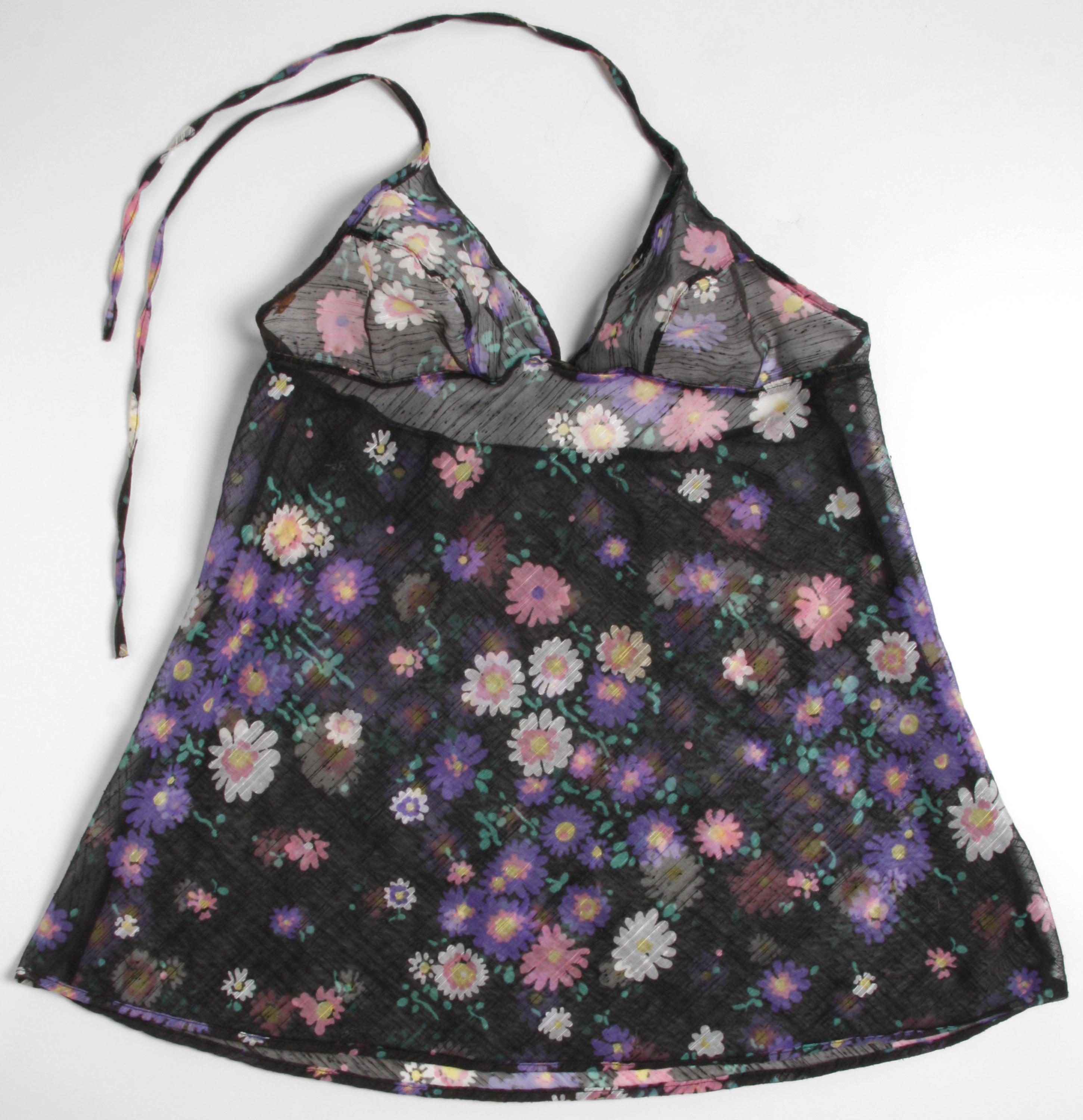 Black sheer swimsuit with floral pattern of small purple, pink and white flowers.