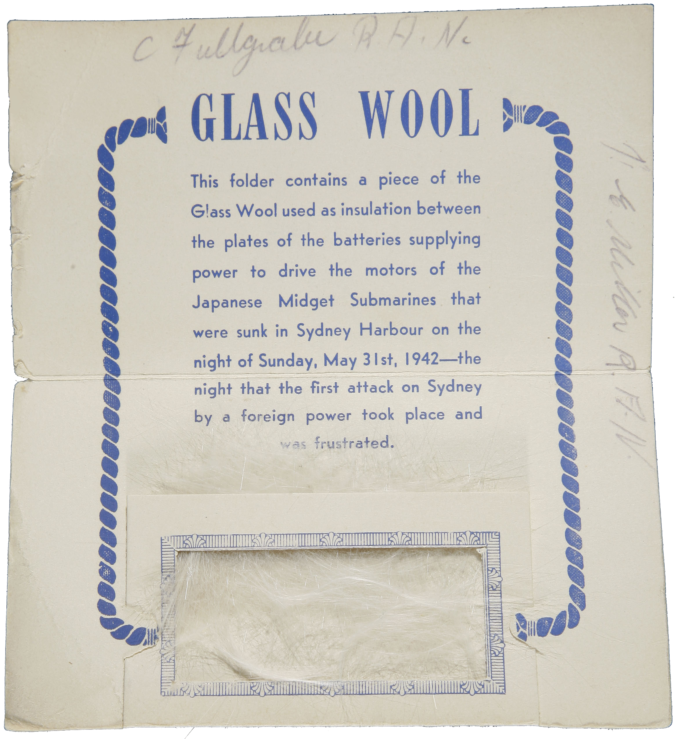 Glass wool fragment in souvenir envelope.text reads: Glass Wool / This folder contains a piece of the / Glass Wool used as insulation between / the plates of the batteries supplying / power to drive the motors of the / Japanese Midget Submarines that / were sunk in Sydney Harbour on the / night of Sunday, May 31st, 1942 - the night that the first attack on Sydney / by a foreign power took place and / was frustrated.