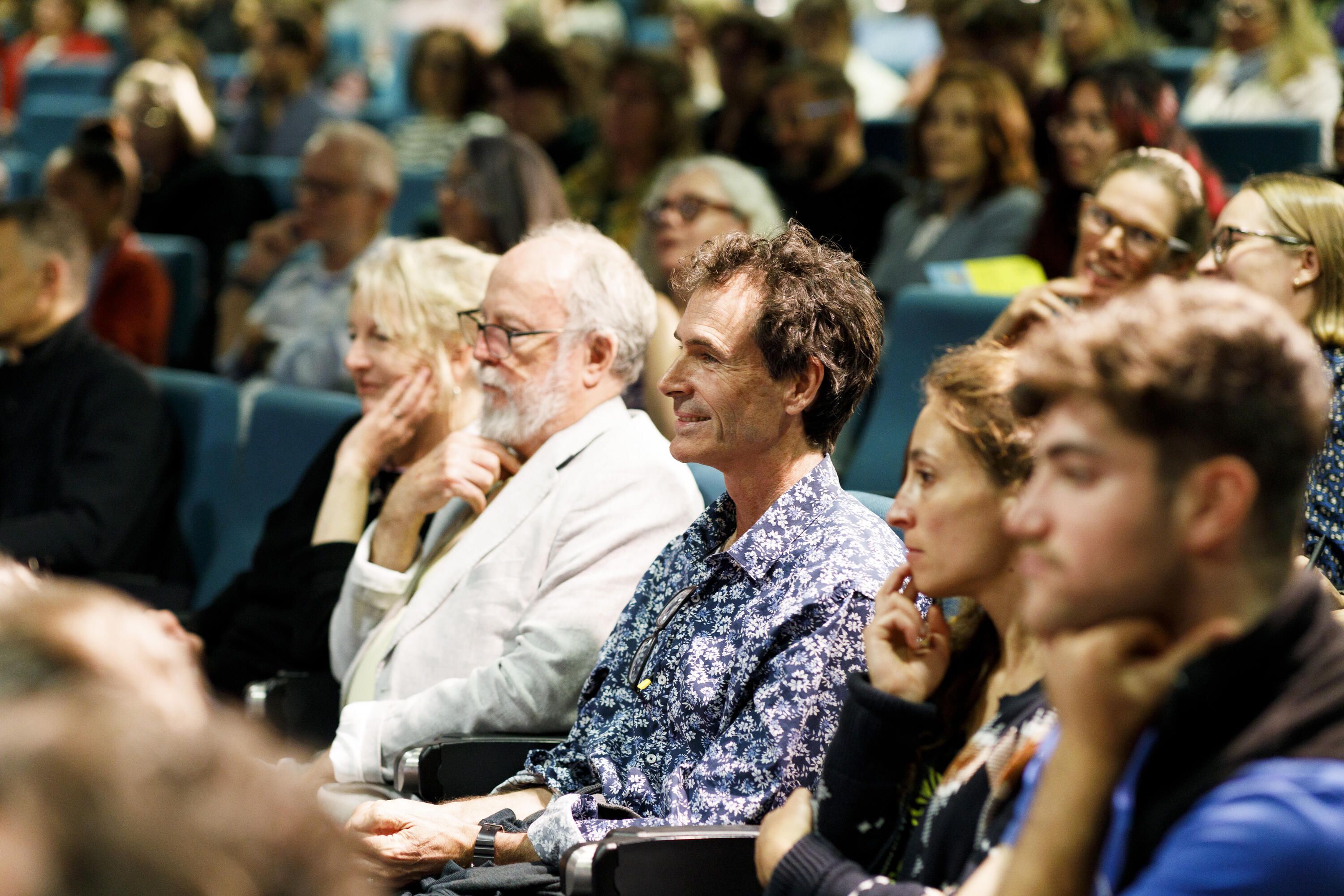 Photo showing people seated in a theatre.