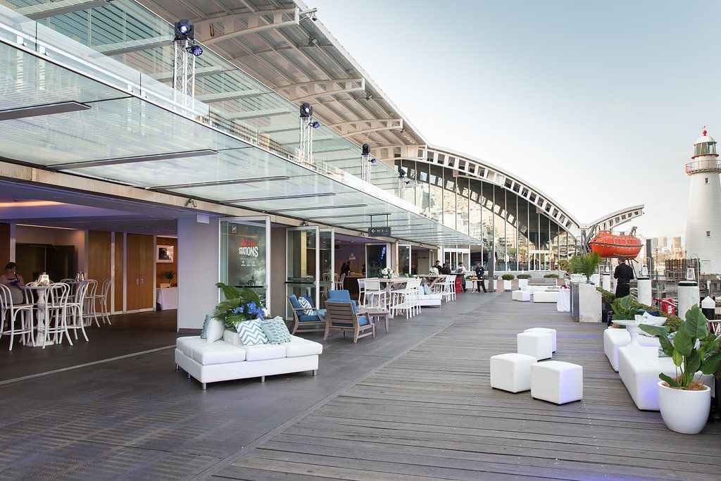 photo of museum boardwalk with glass wall open to interior event space.
