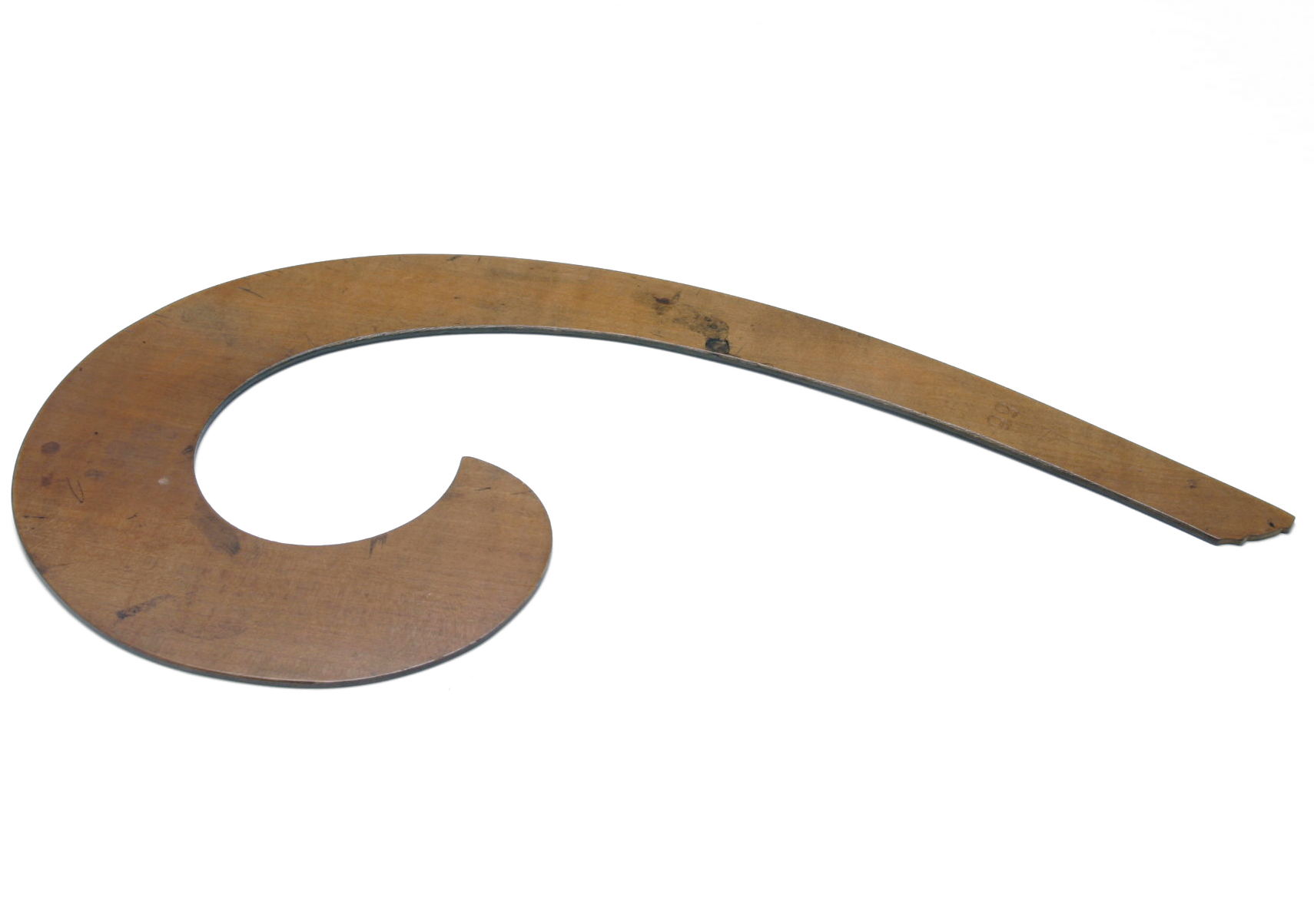 Wooden lamina drafting curve with ink stains on both sides.