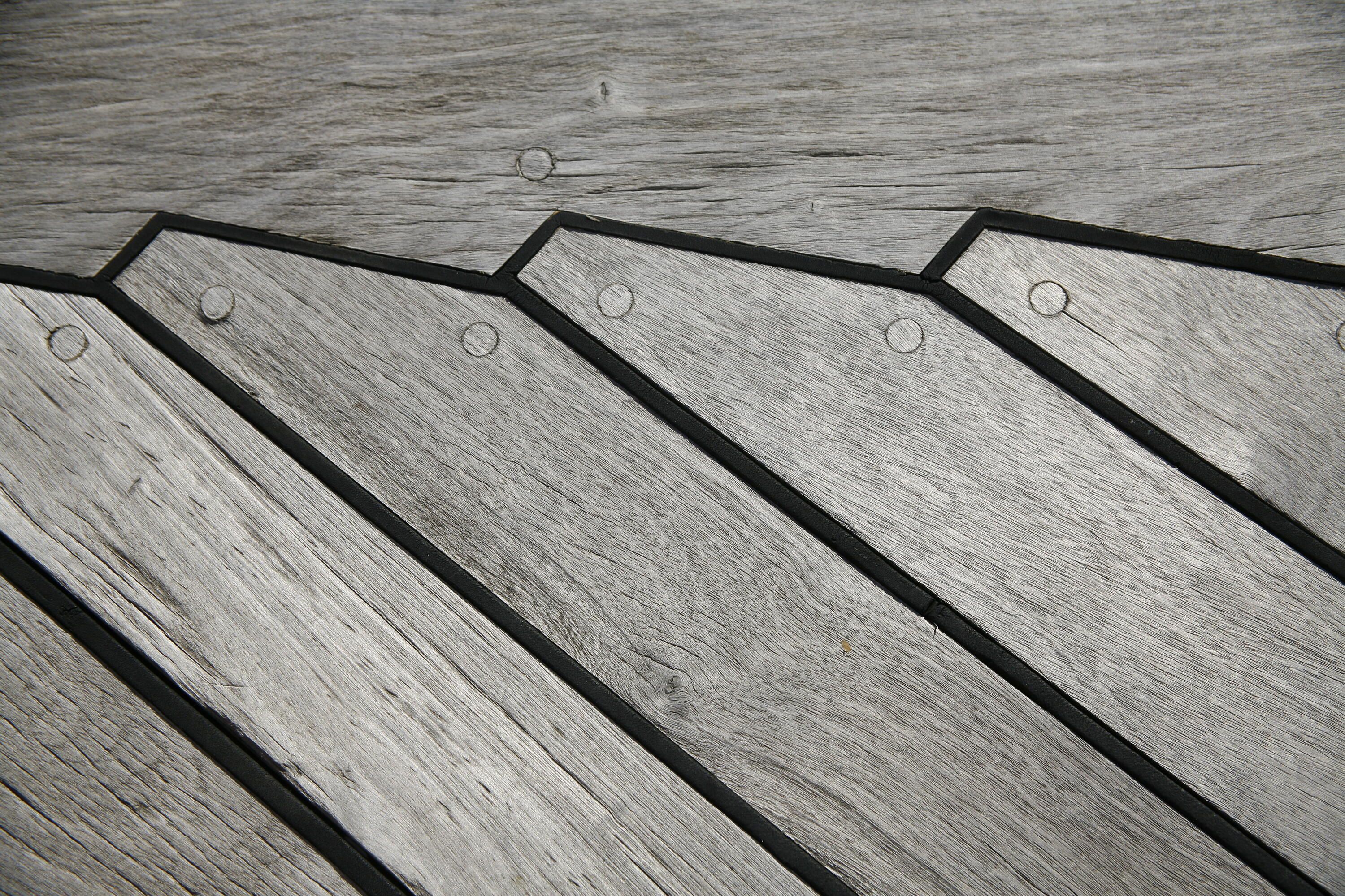Close up photo of grey timber decking.