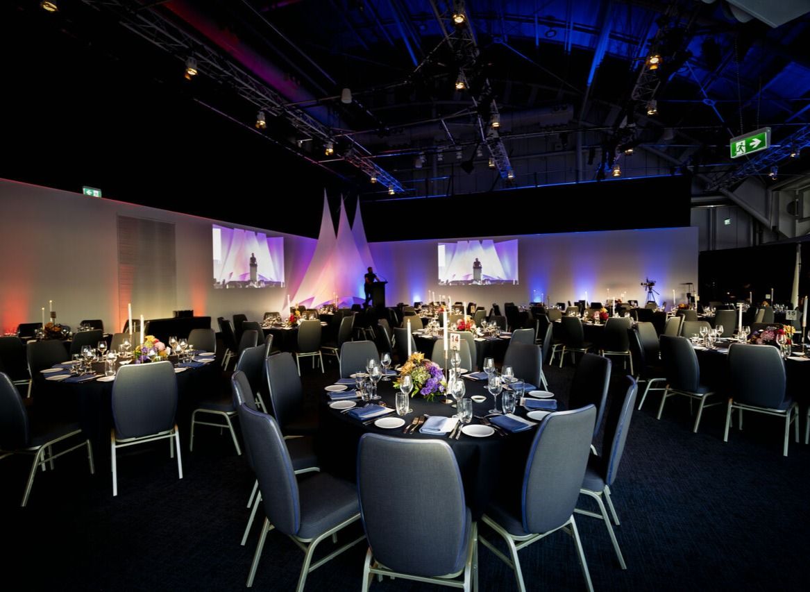Photo of a museum event space with round tables.