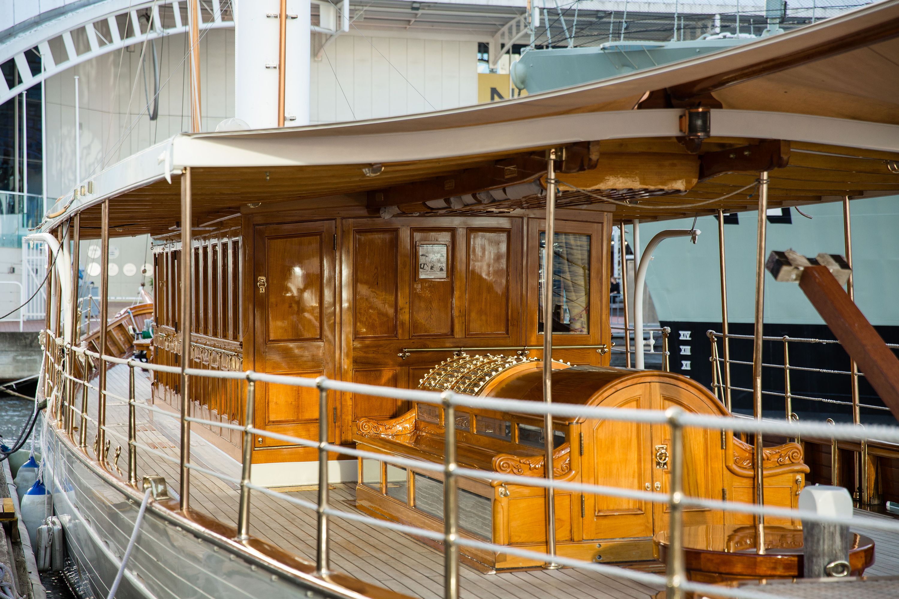 Photo showing the deck and cabin of an wooden steam yacht.