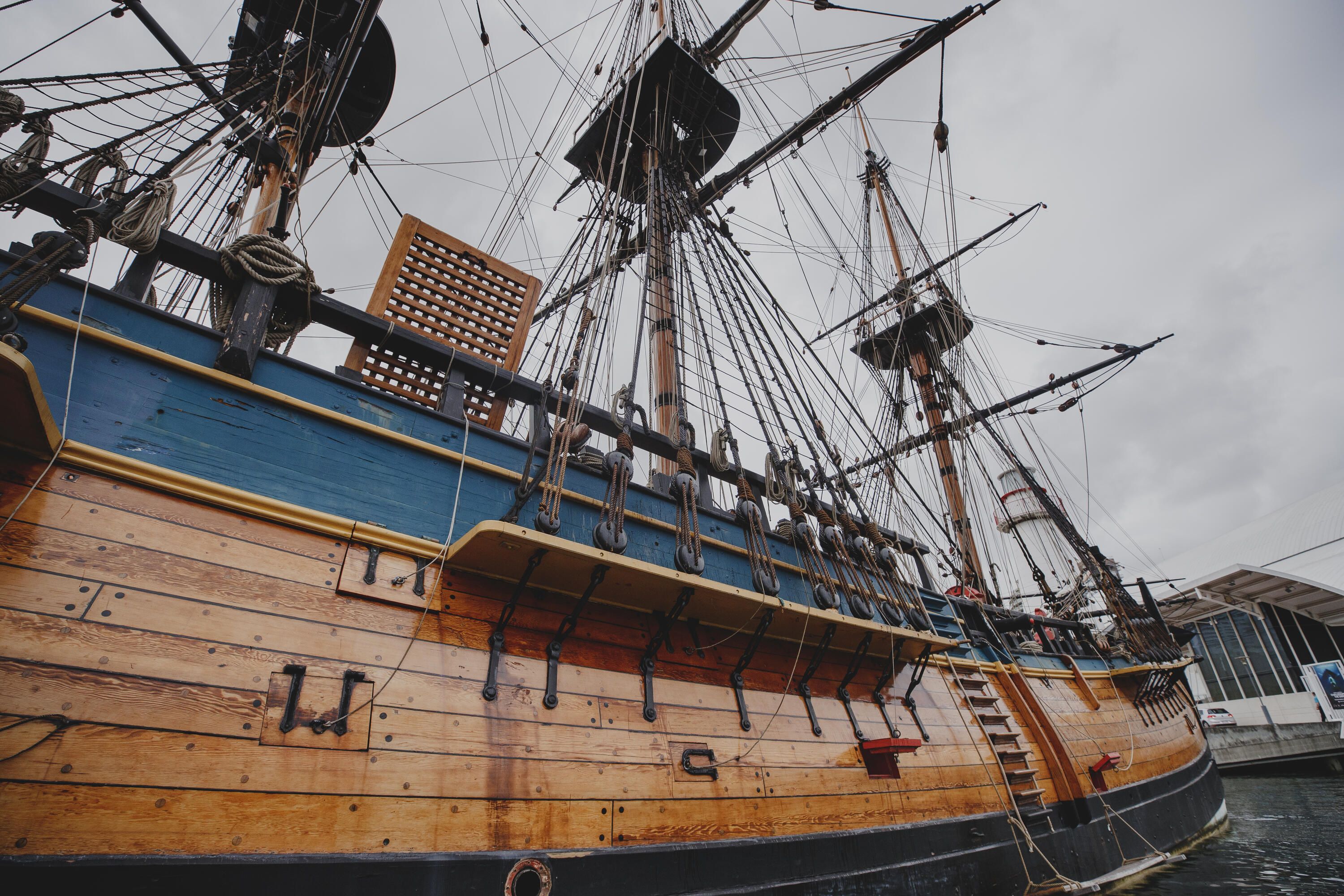 Photo showing the side of a wooden tall ship.