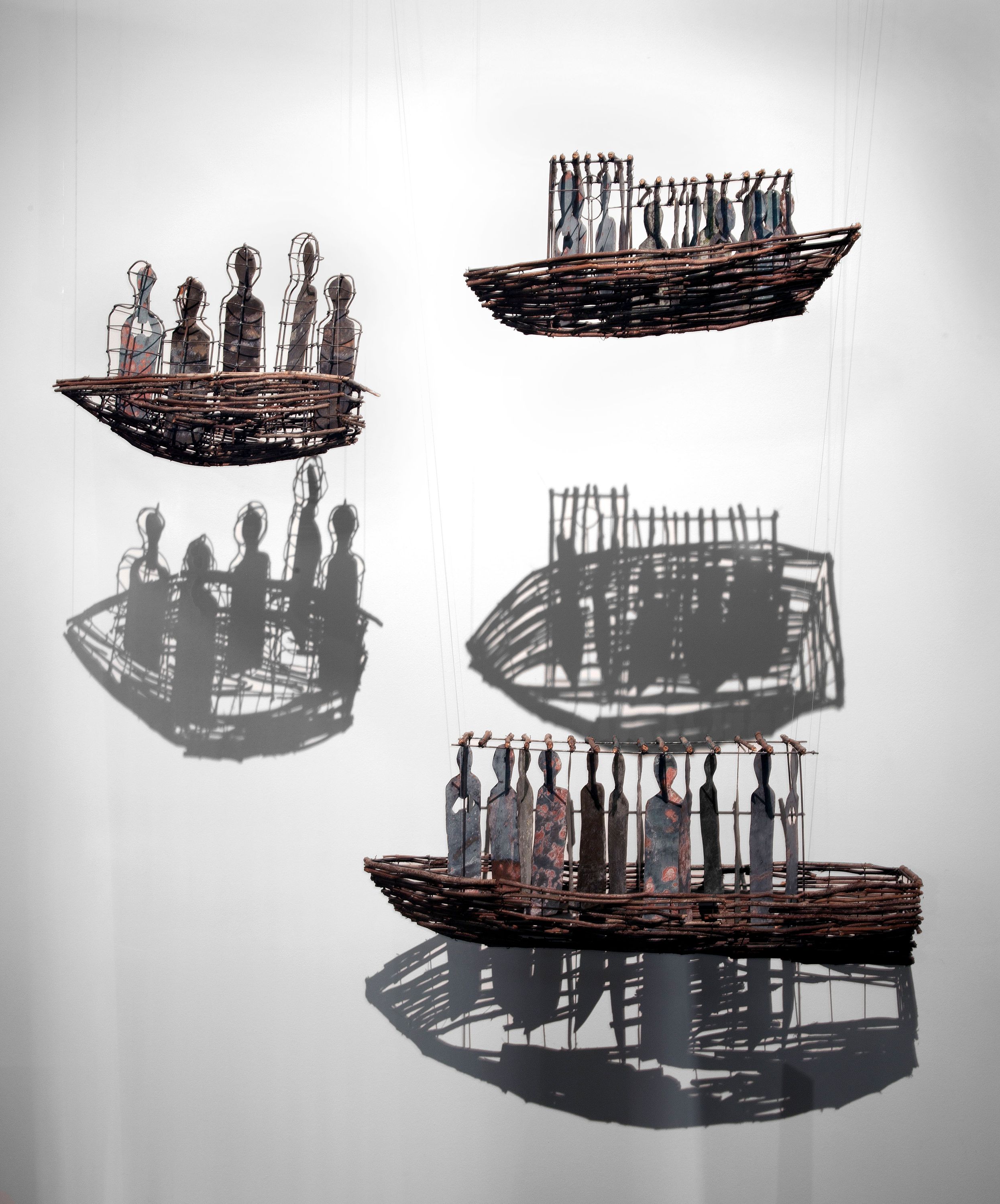 Photo showing an original work of art comprising six boats constructed from wood, steel and brass