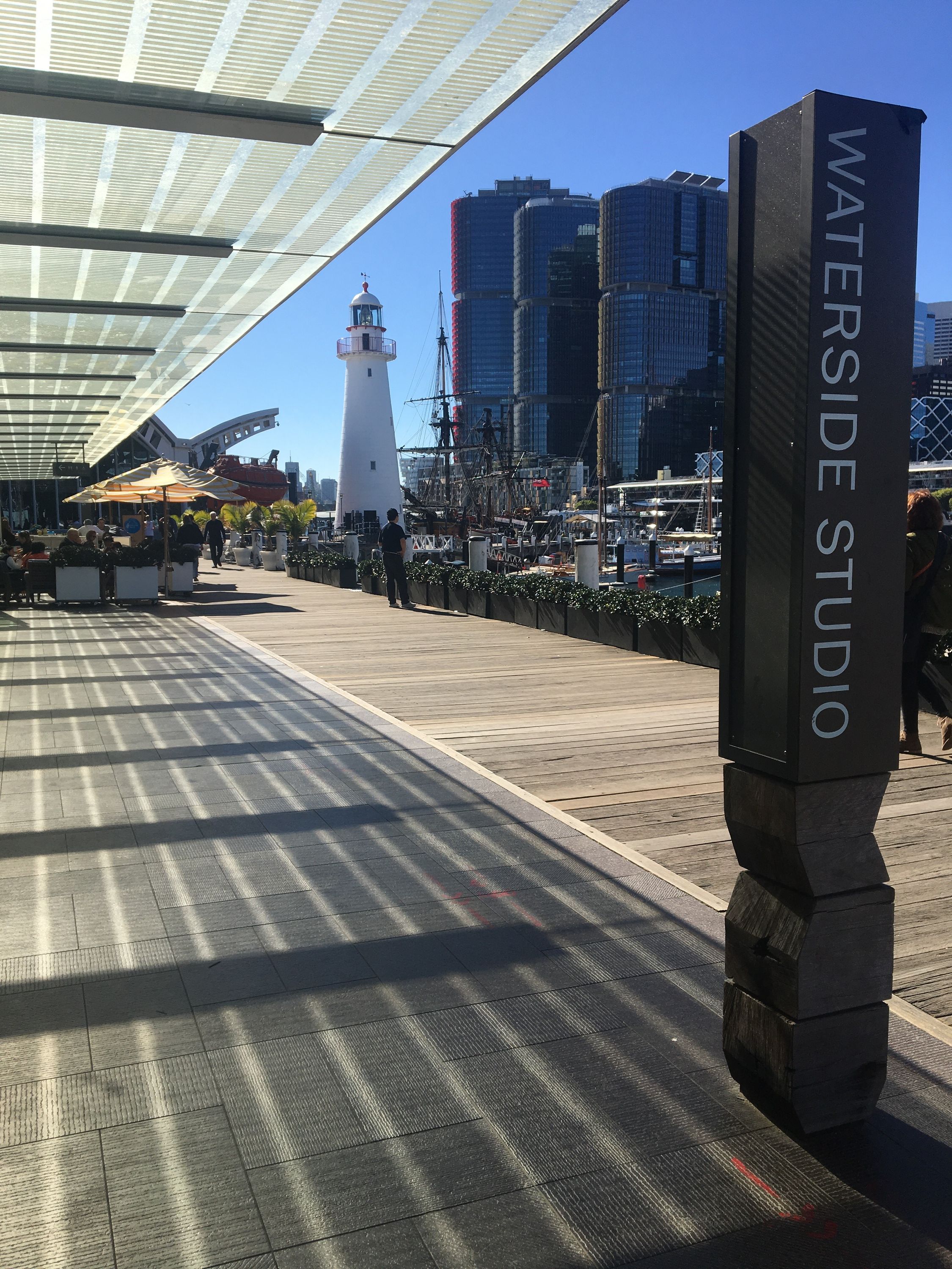 photo of museum boardwalk with Sydney skyline in the background