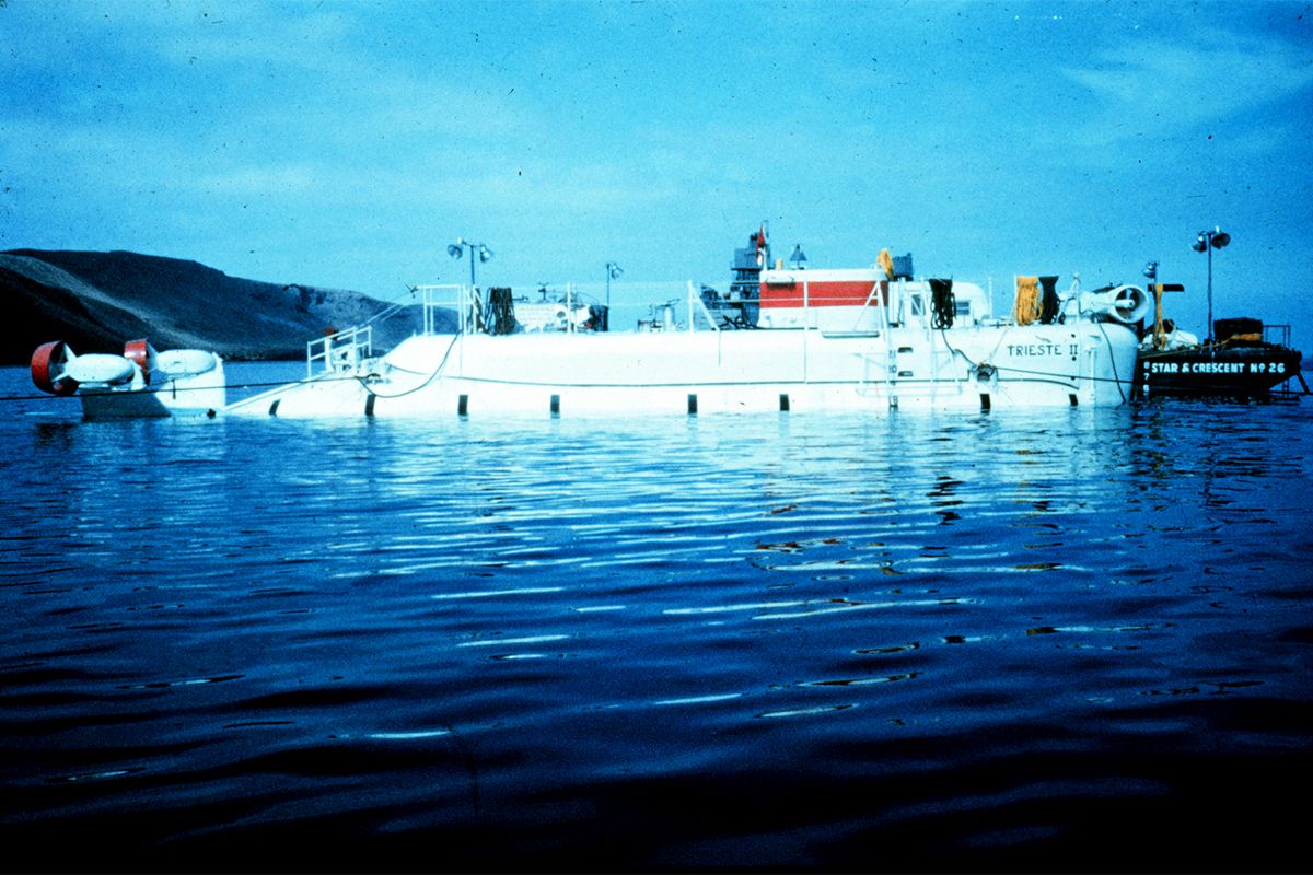 Photograph showing a white submersible on the surface of the water.