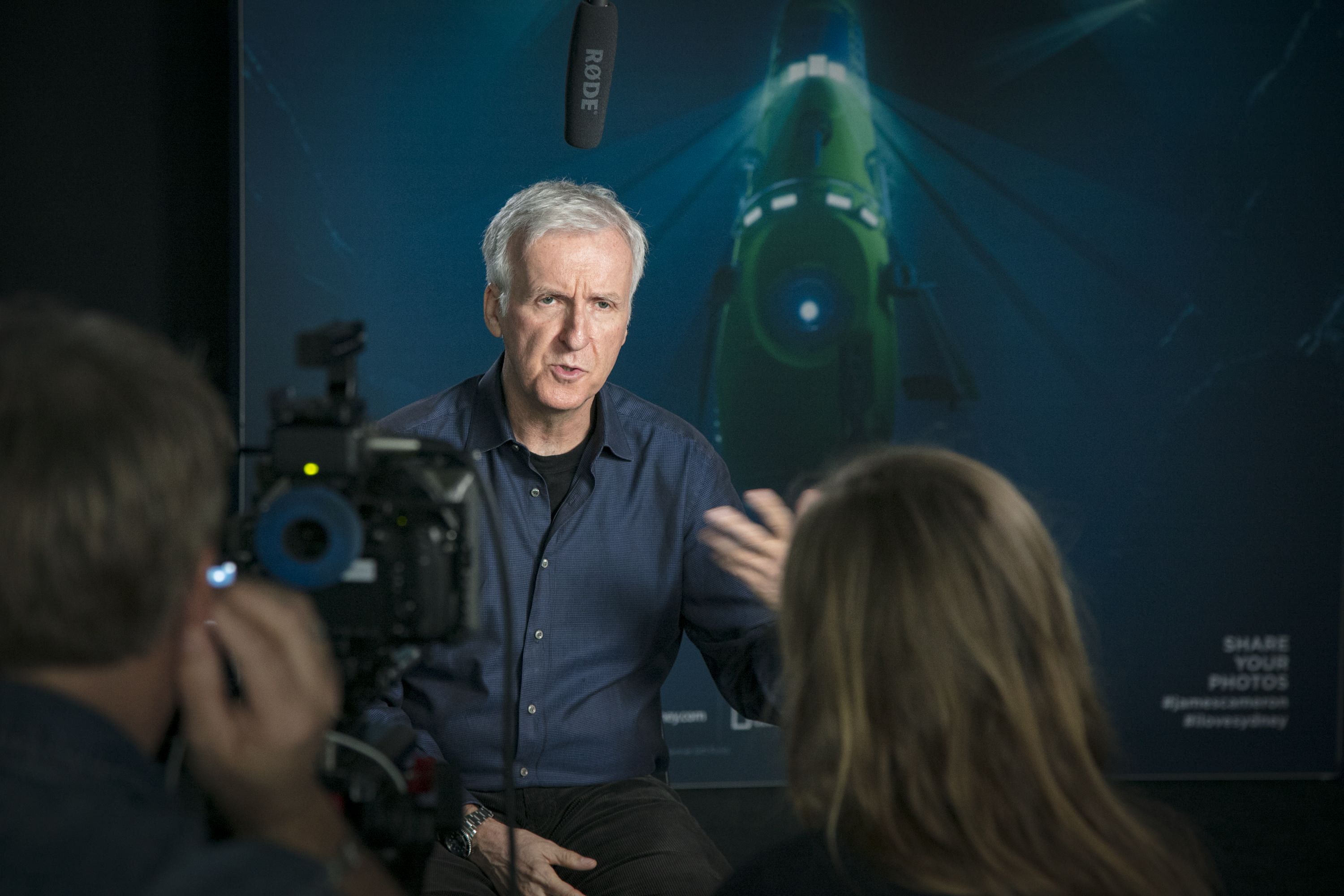 Photo of a man, James Cameron, being interviewed by the media. 