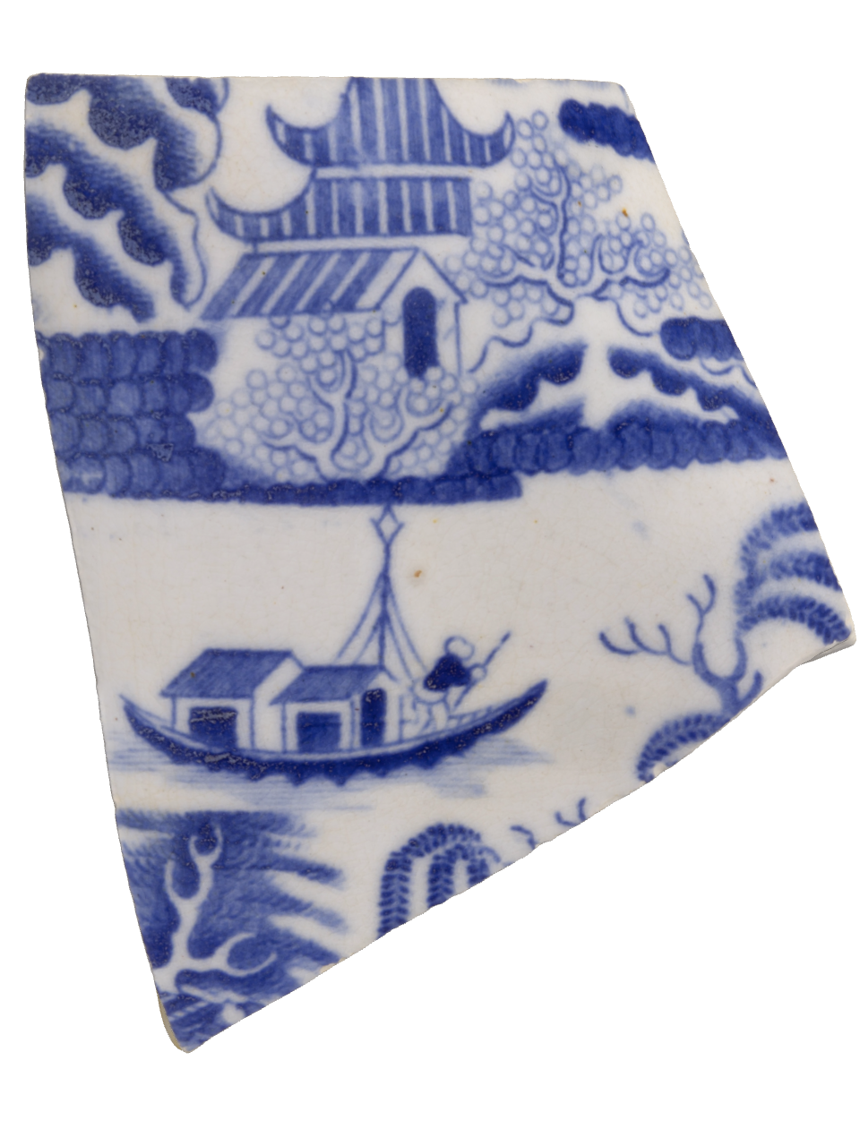 Photo of a fragment of pottery with blue illustrations on a white background.
