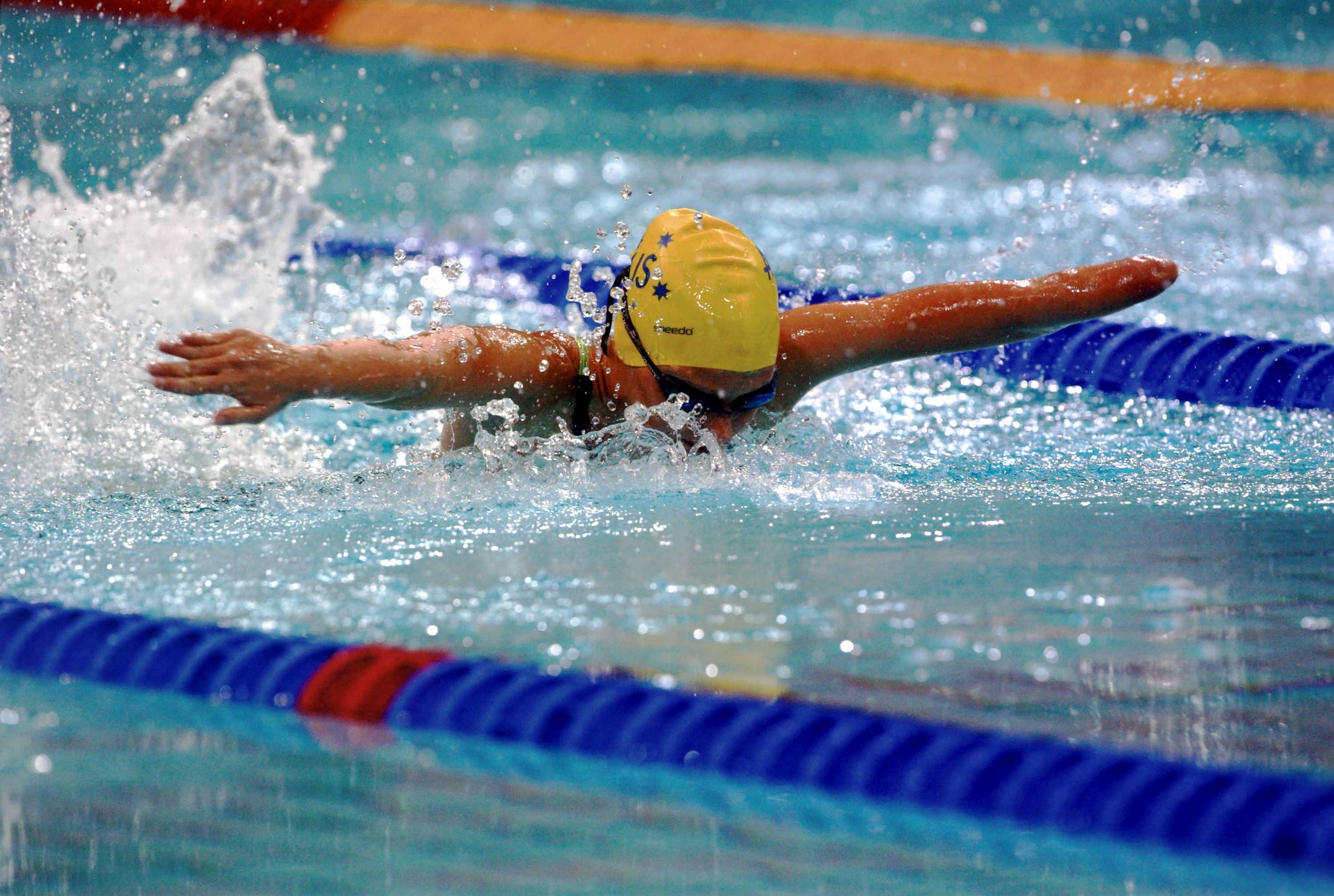 Photo of a Paralympic athlete doing a butterfly stroke in a pool.