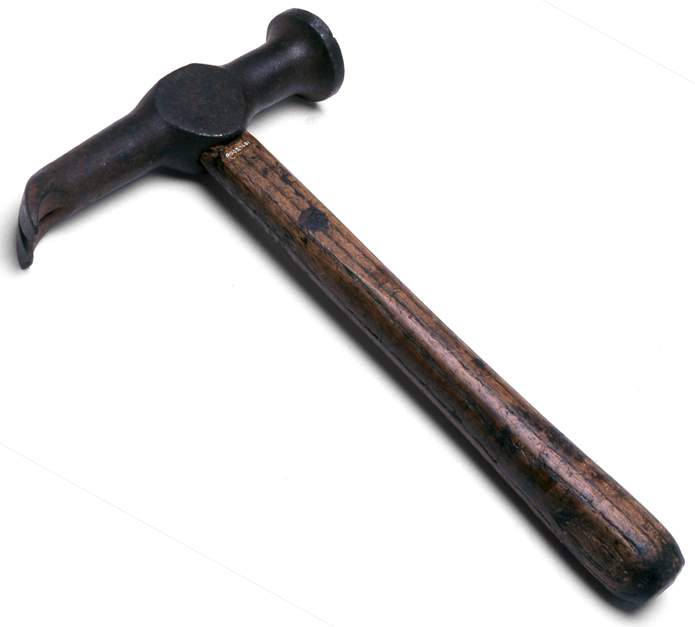 Boat building hammer featuring a head with a wide face and a long claw made from tempered steel, and a straight wooden shaft. The initials 'W K' are crudely engraved onto the side of the claw. 