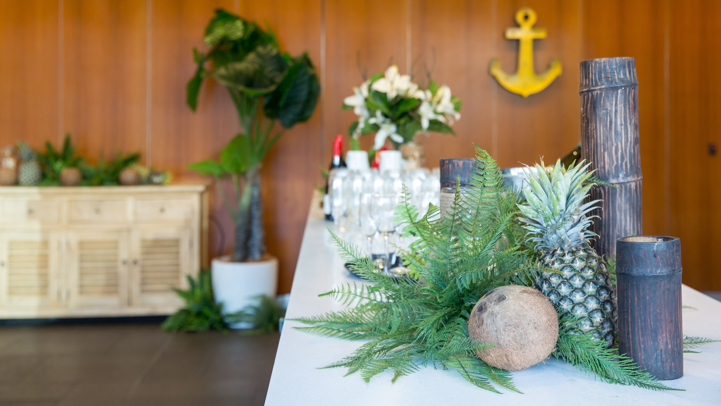 close up photo of natural decorations on a white table cloth, with a wooden wall in the background.