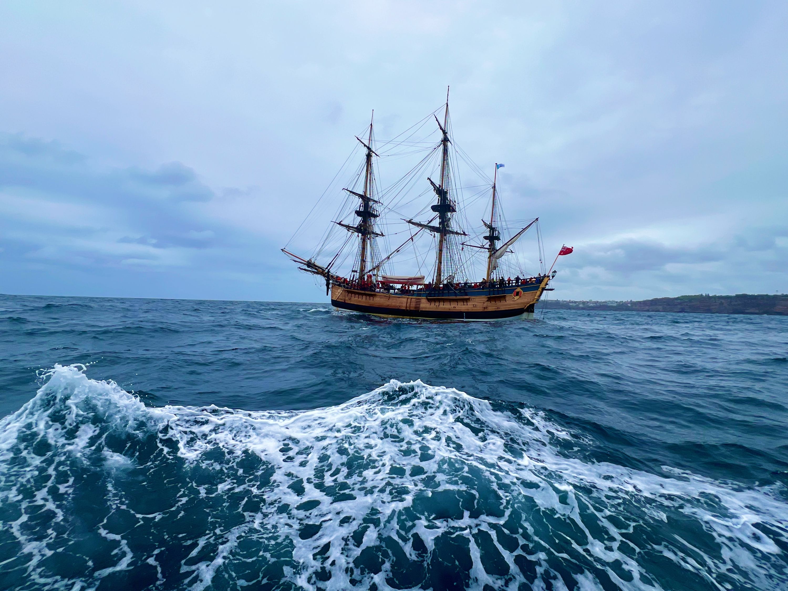 Full wide view of Endeavour sailing with waves in the foreground