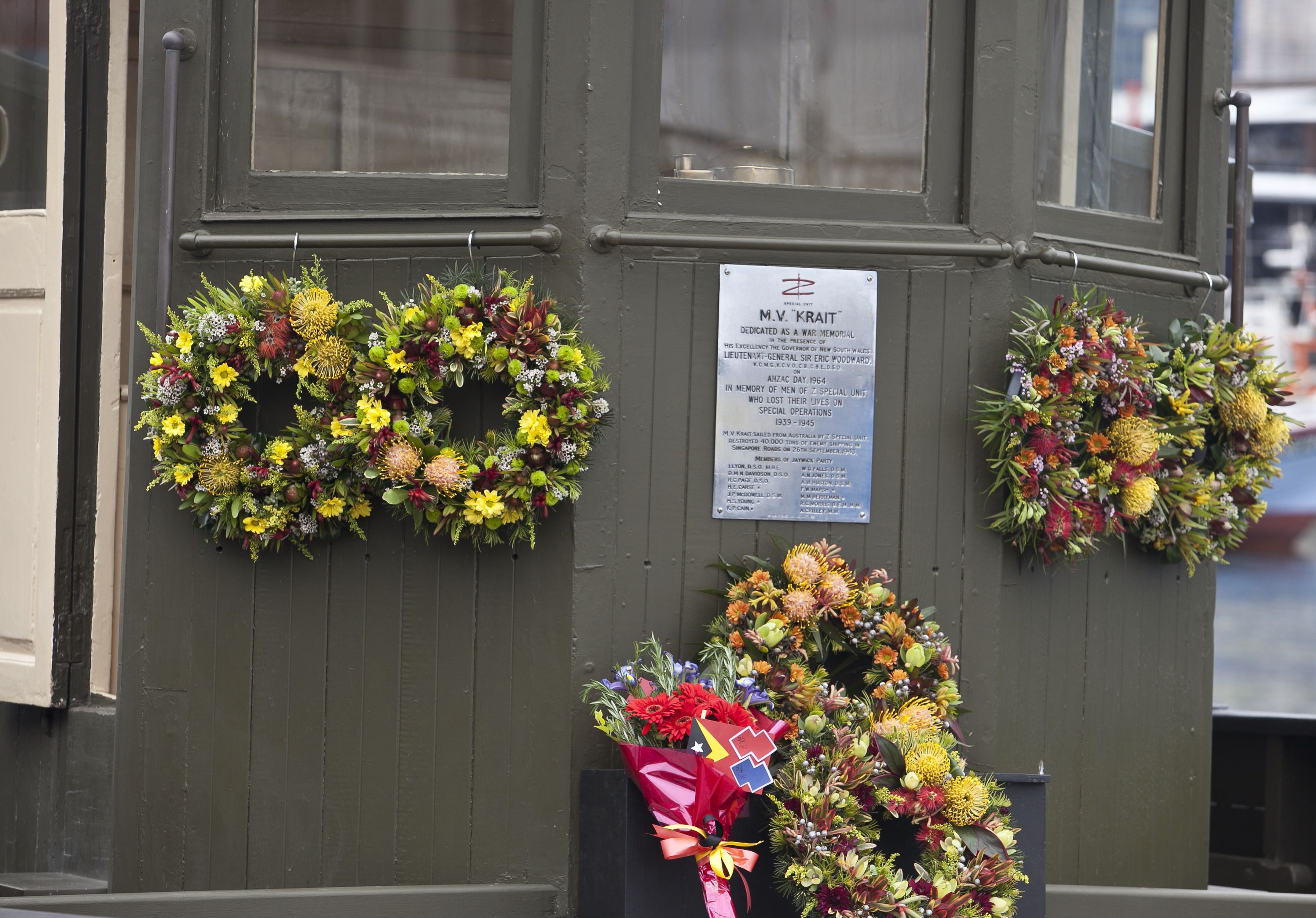 Close up photo of MV KRAIT with floral wreaths.