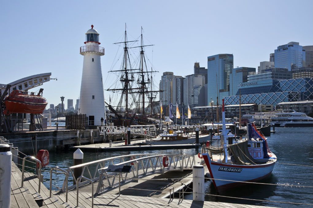 Photo showing Museum vessels moored at the wharves. Including Vietnamese refugee boat Tu Do in foreground and Endeavour in background