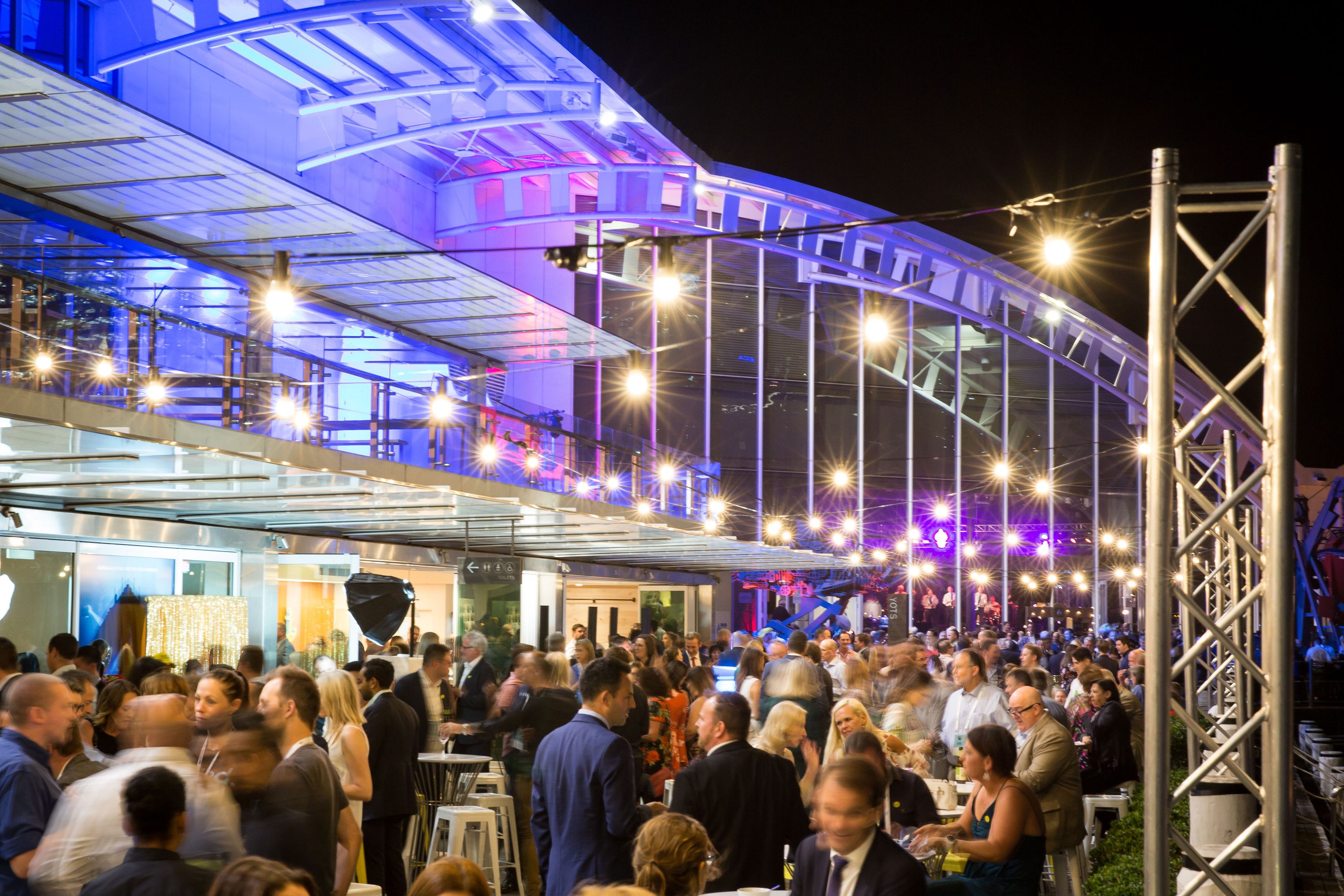 The museum precinct filled with crowds during a corporate event at night