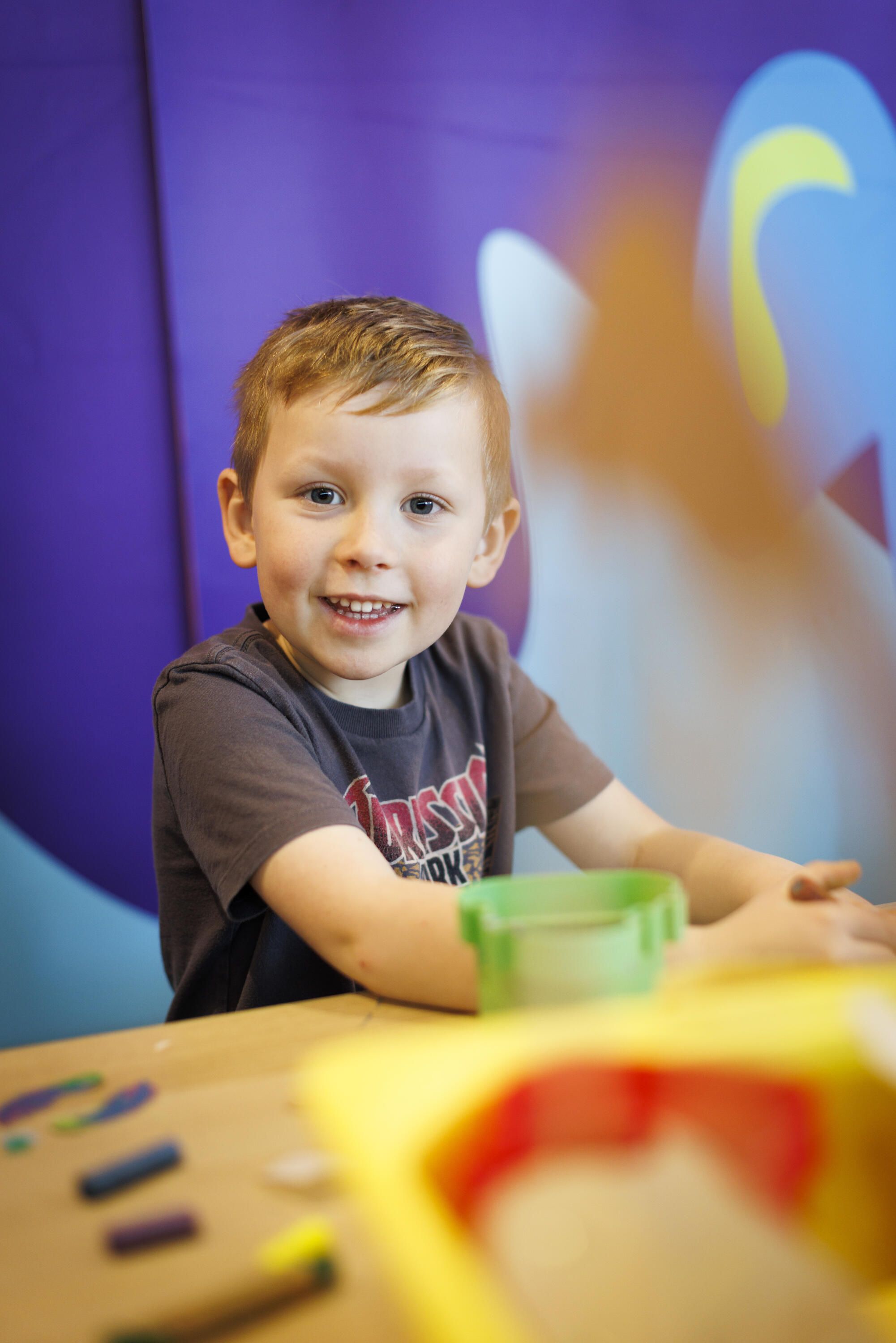 A young boy having fun in the creative space.