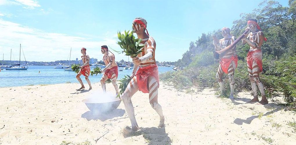 Group of First Nations Dancers on a beach