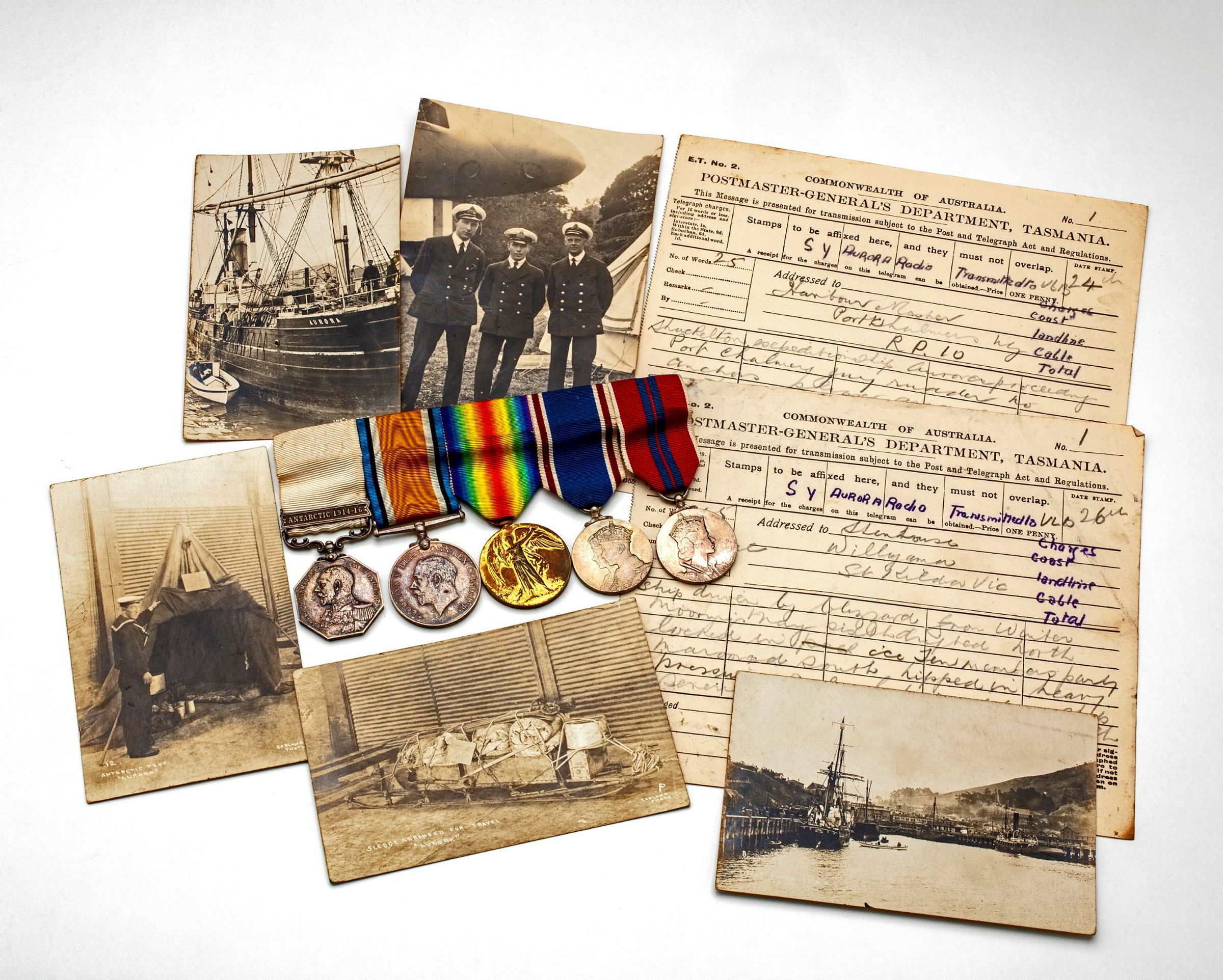Photo showing a selection of photos, documents and service medals on a white backdrop.
