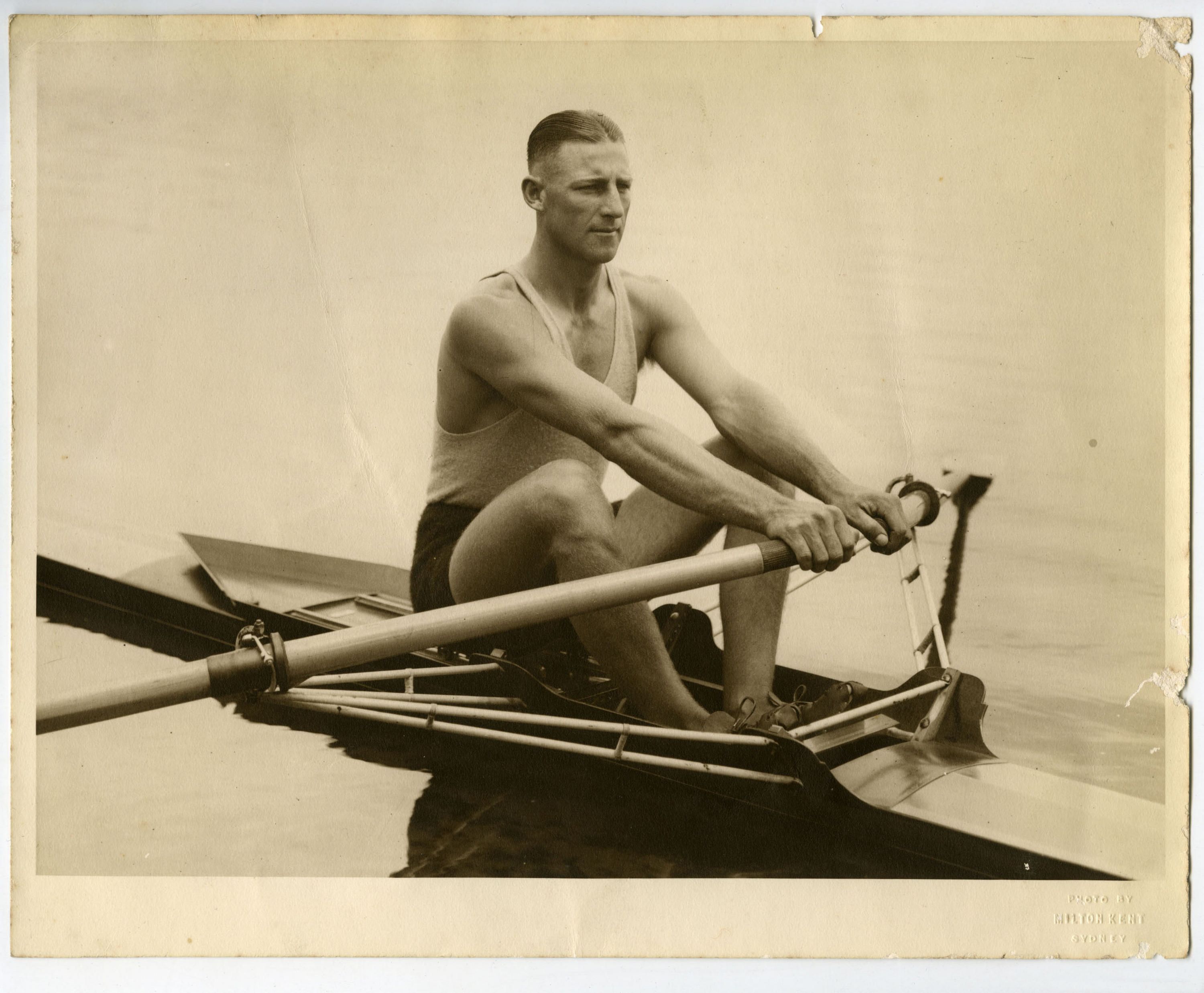 Black and white photo of a man in a row boat