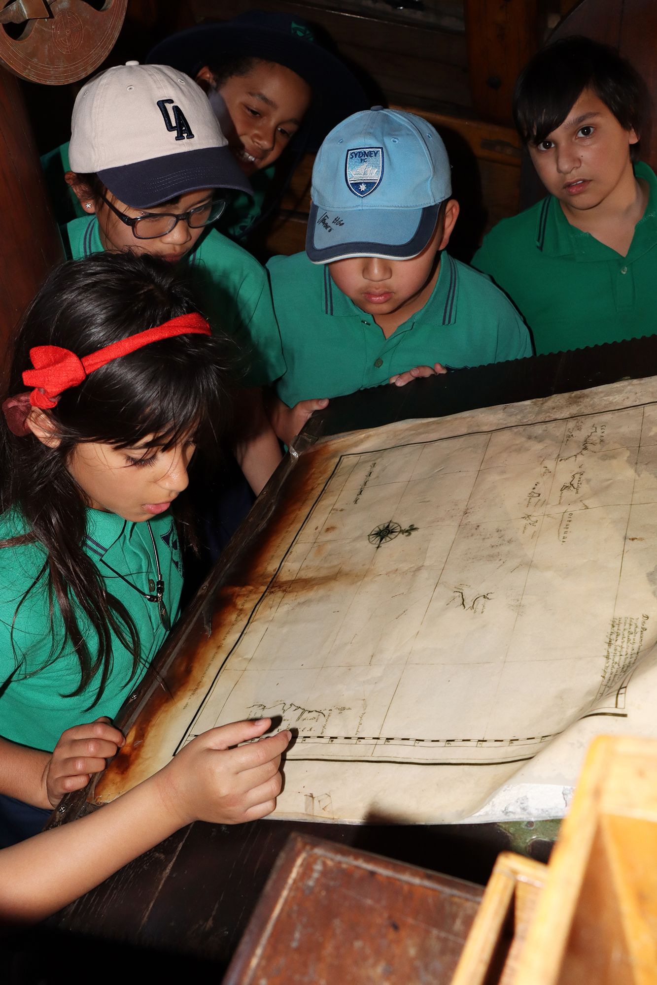 Photo of primary school students looking at a map.