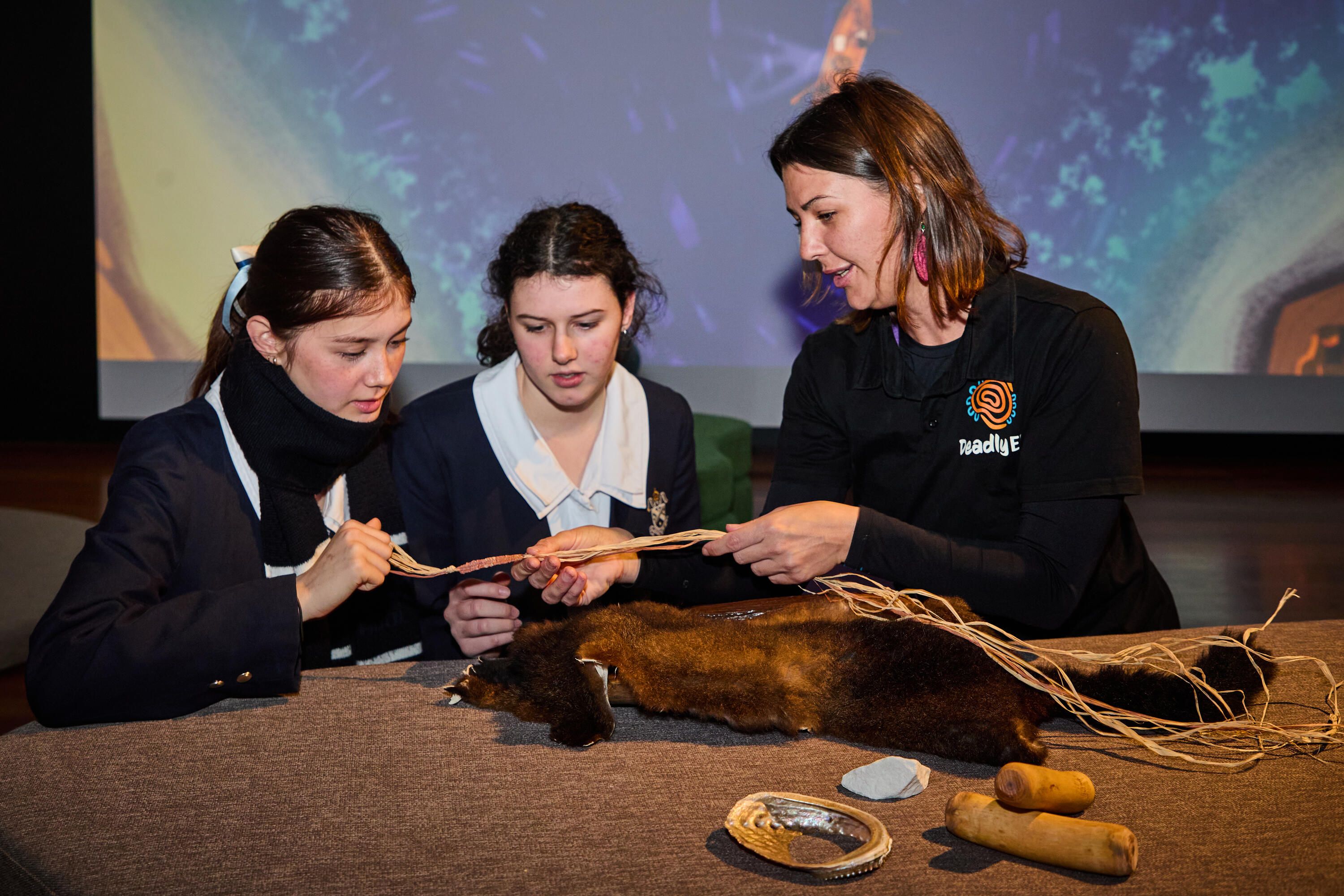 Photo of 2 female high school students and an adult woman, first nations educatior