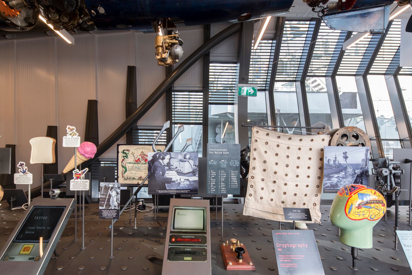 Photo showing an interior view of a museum exhibition display featuring objects about life in the Navy.