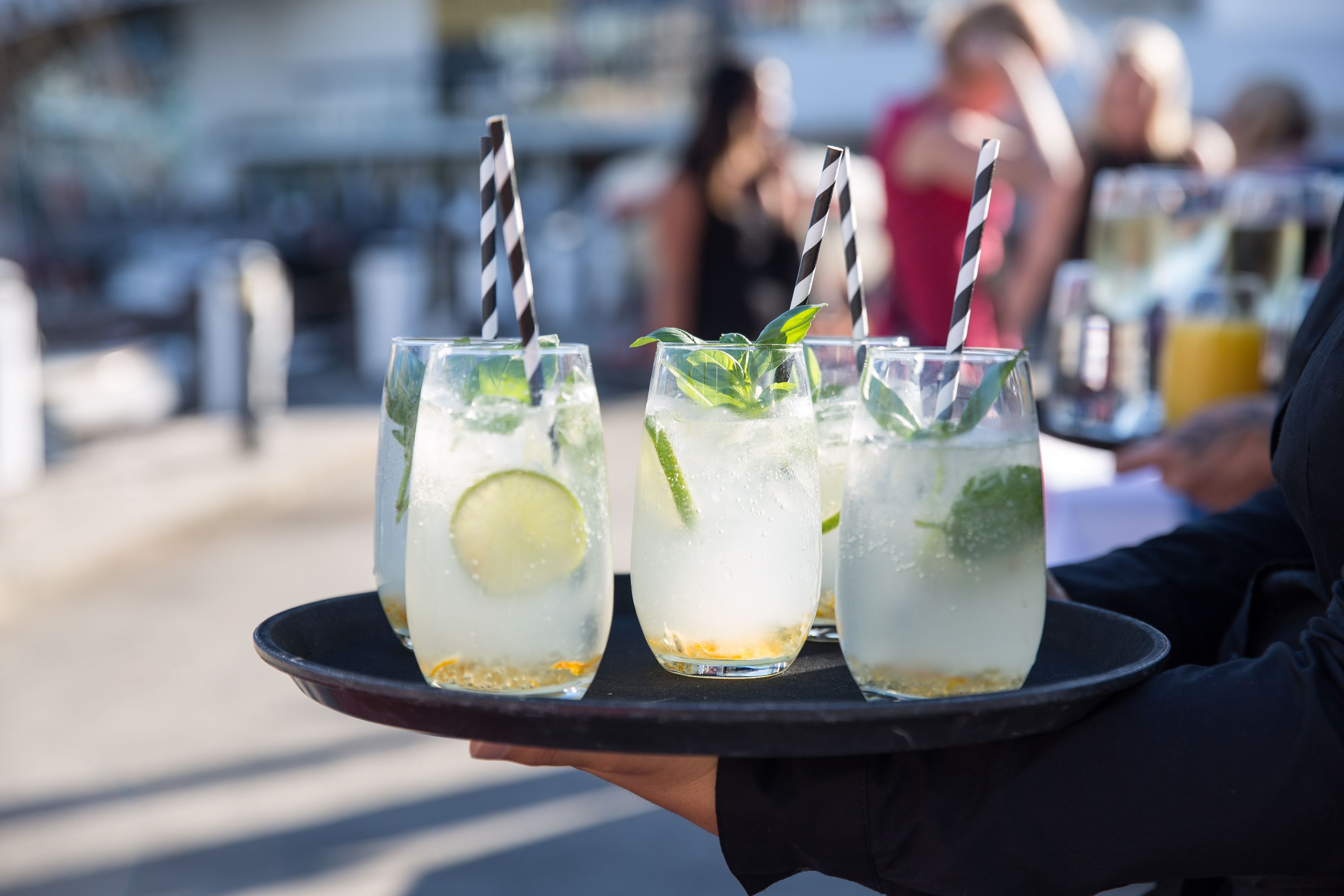 close up photo of lemonade glasses on a tray with a blurred background