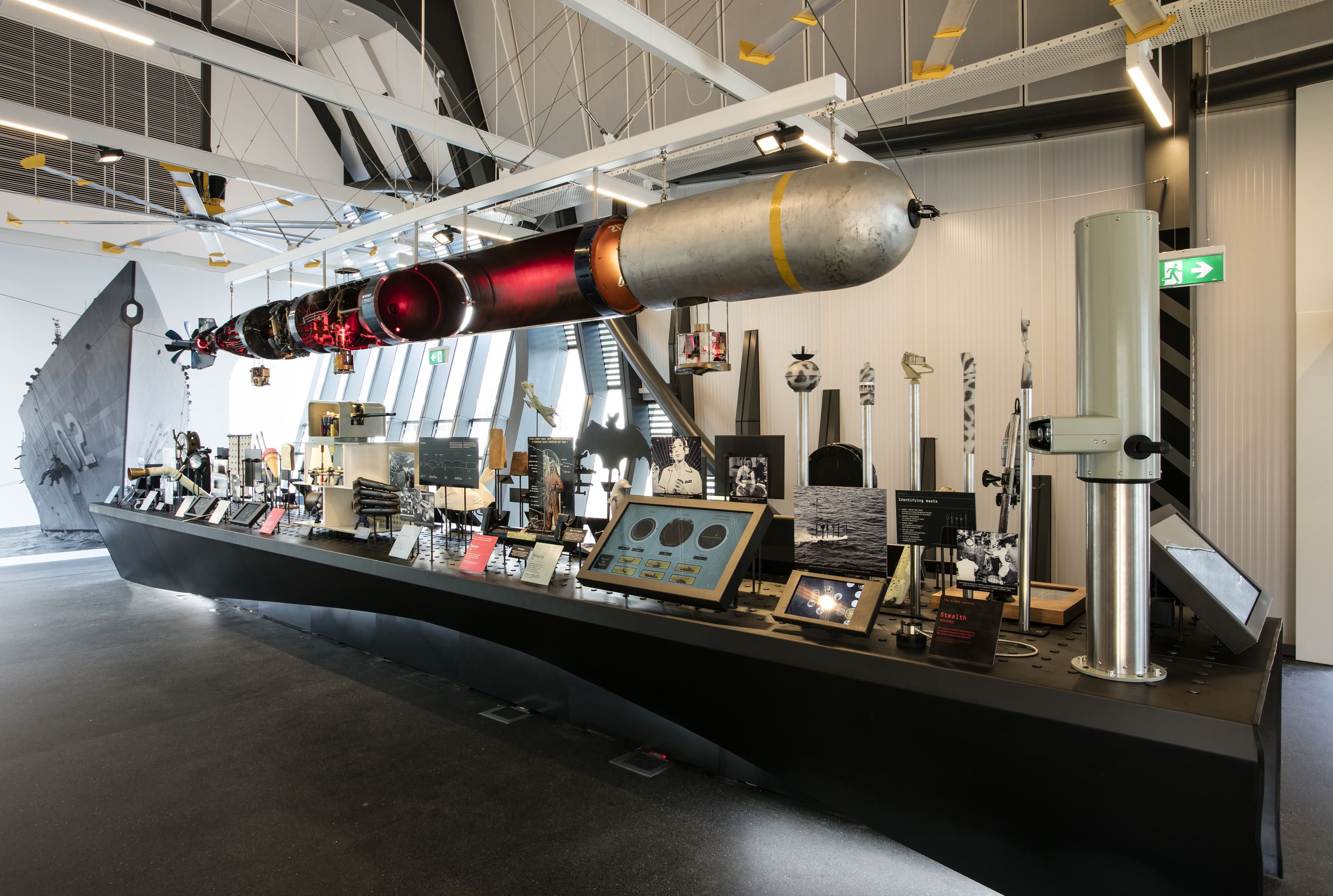 Photo showing an interior view of a museum exhibition display featuring objects about life in the Navy 