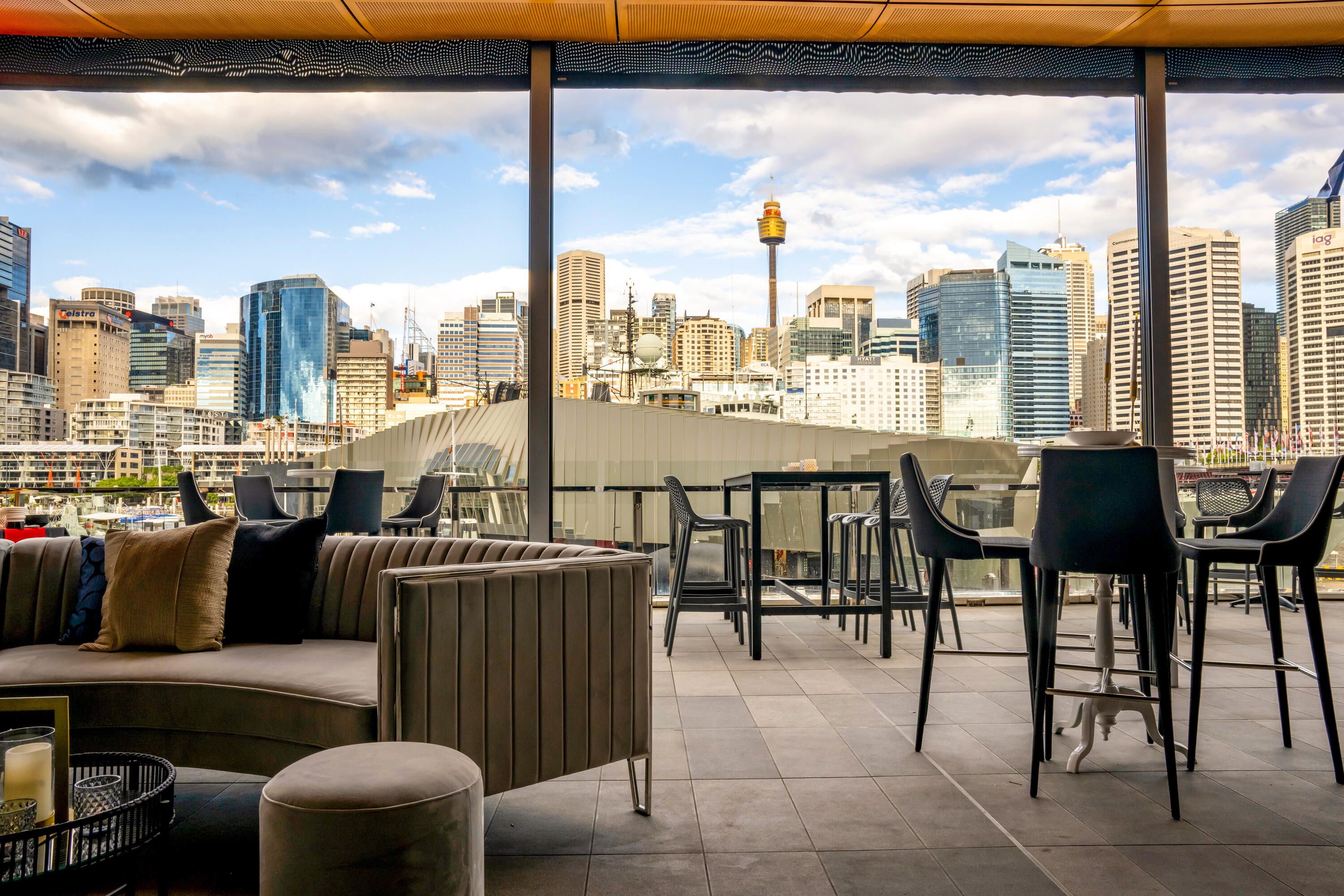 Event space with lounge furniture and view of the city skyline