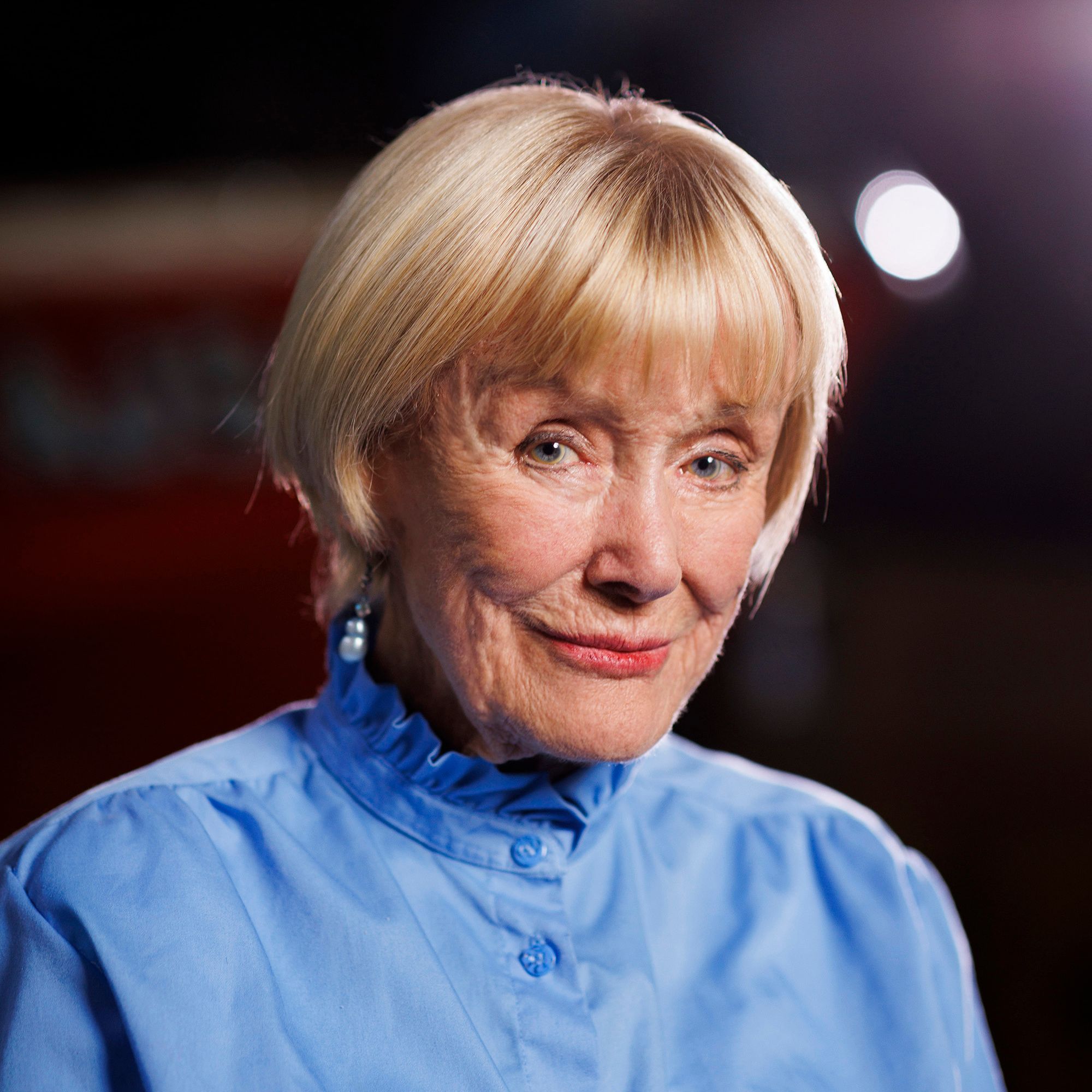 Photo of Valerie Taylor, with short blonde hair and a blue shirt.