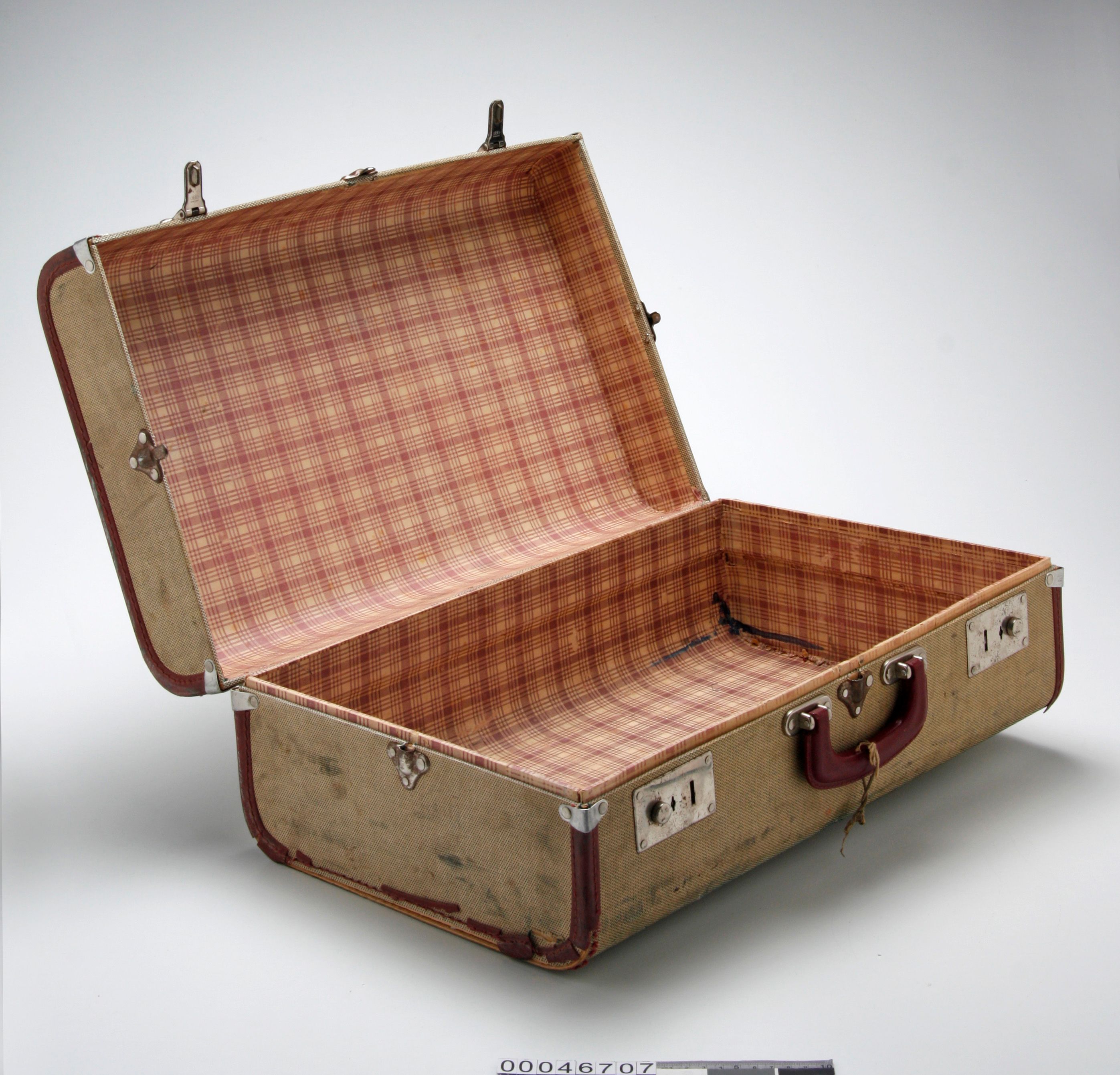 Cream suitcase with maroon trim and handle, and a checked pattered lining