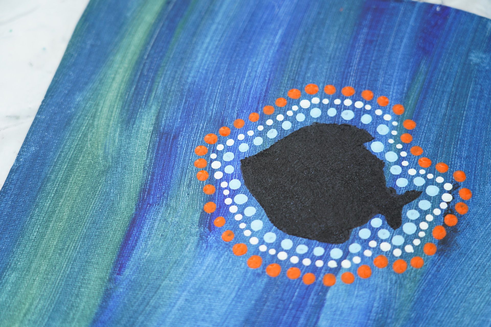 Photo showing a close up of a dot painting artwork. 